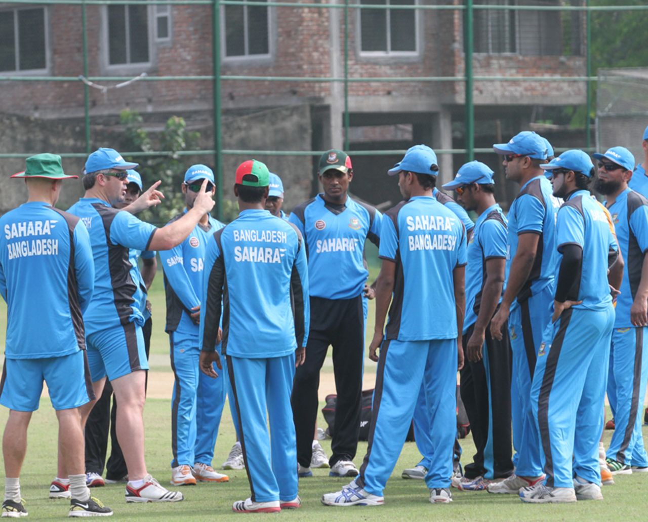 Bangladesh players are instructed by fielding coach Jason Swift ahead of a training session, Mirpur, August 25, 2012