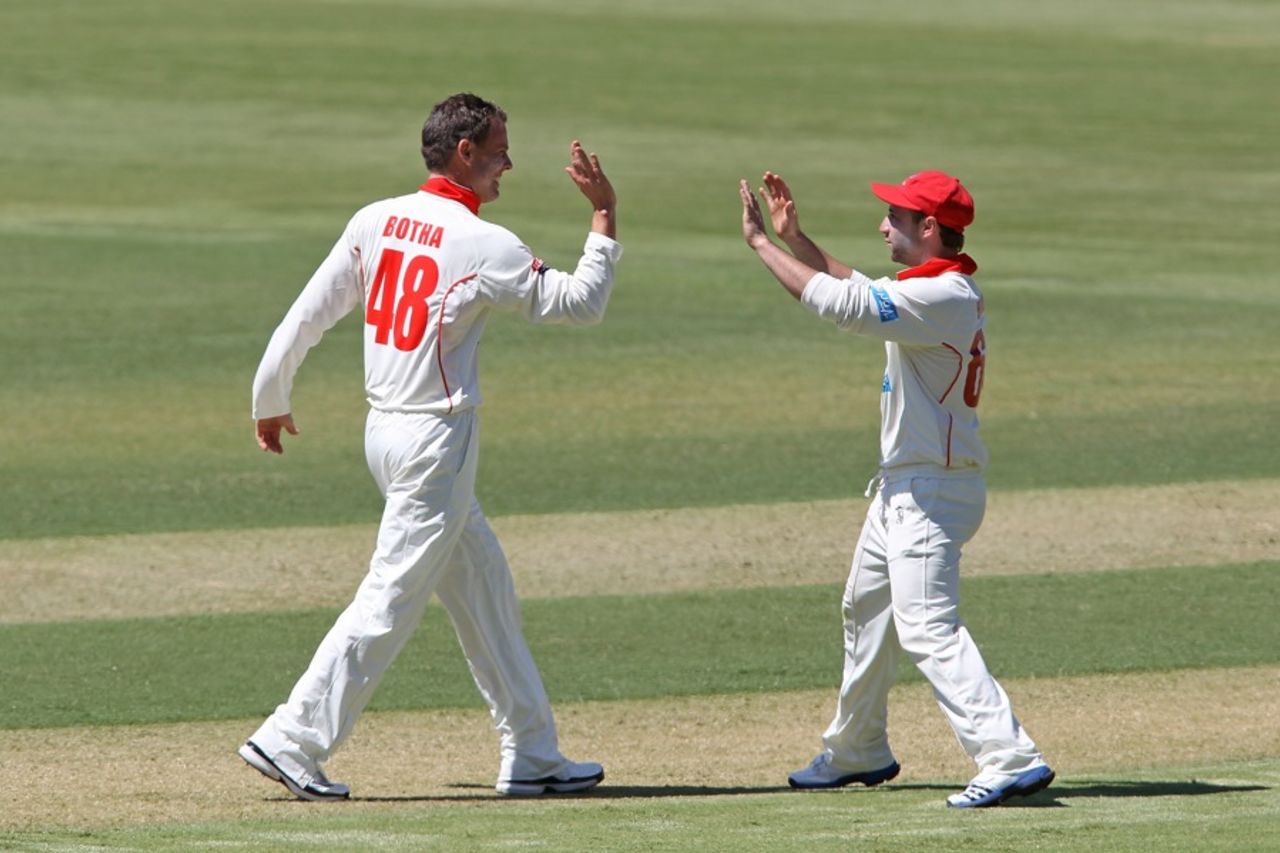 Johan Botha celebrates the wicket of Ed Cowan with Phillip Hughes, South Australia v Tasmania, Sheffield Shield, day one, Adelaide, October 9, 2012