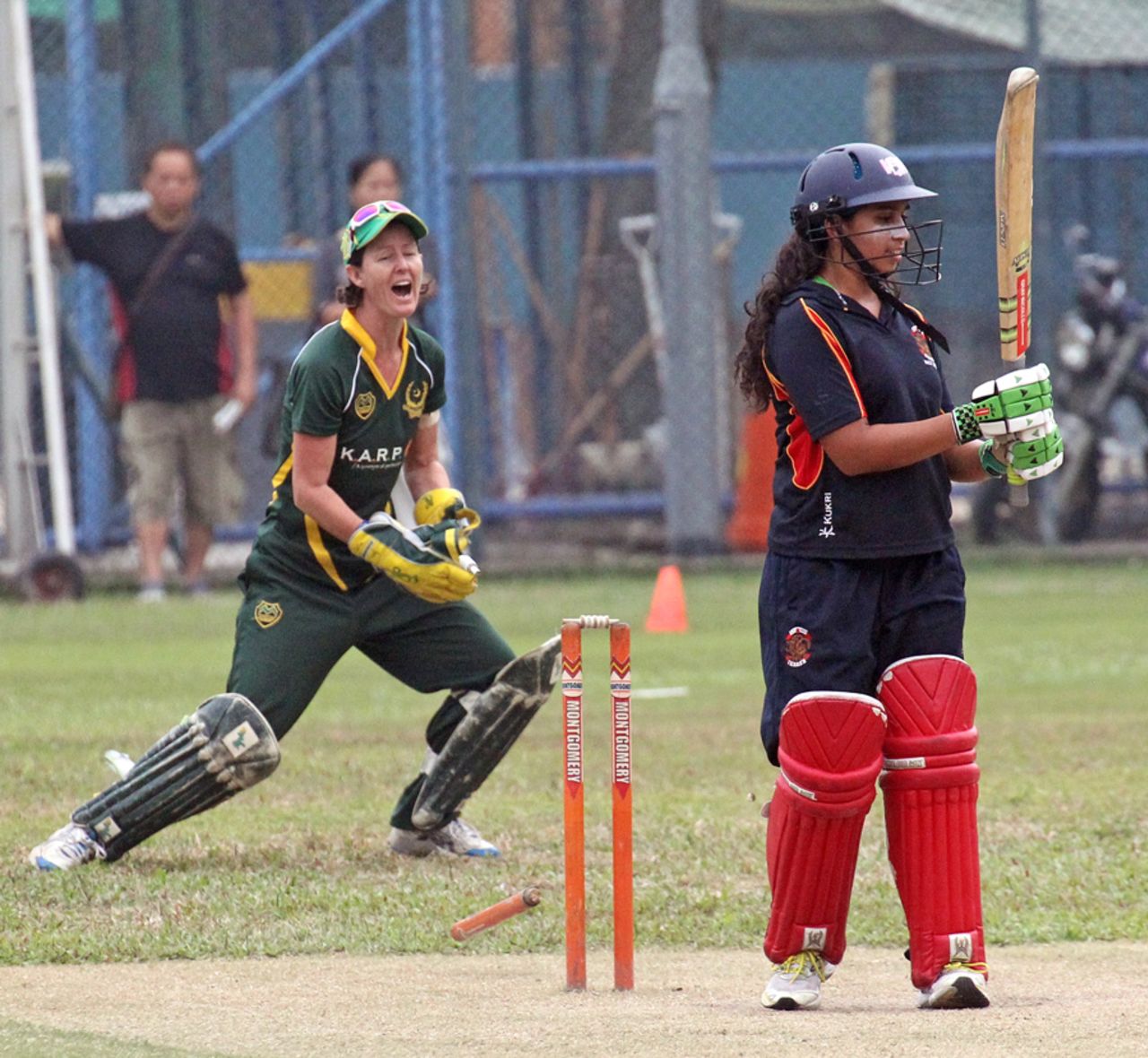 Pakistan Association's Neisha Pratt celebrates a rare success as HKCC Willow Wielders' Ishitaa Gidwani is bowled during the Women's T20 Cup final at Mission Road on 14th October 2012
