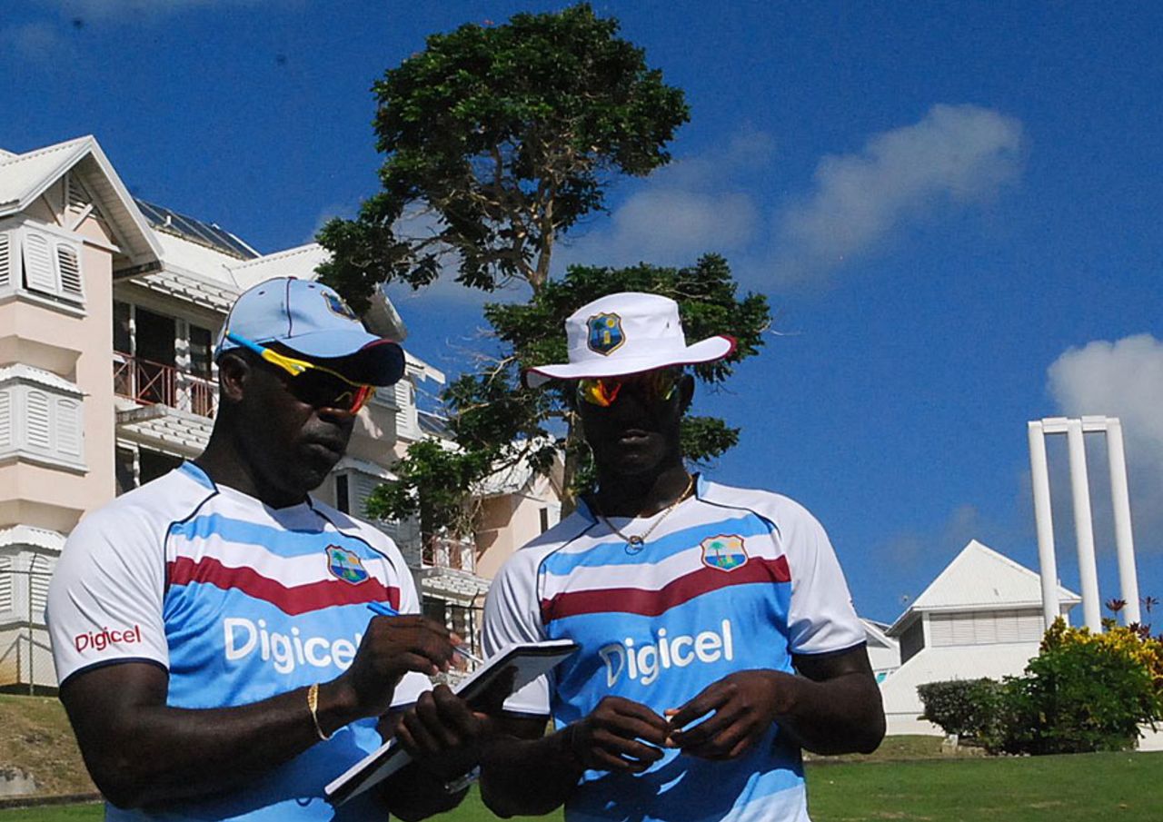 Ottis Gibson and Darren Sammy make notes during training, Barbados, October 29, 2012