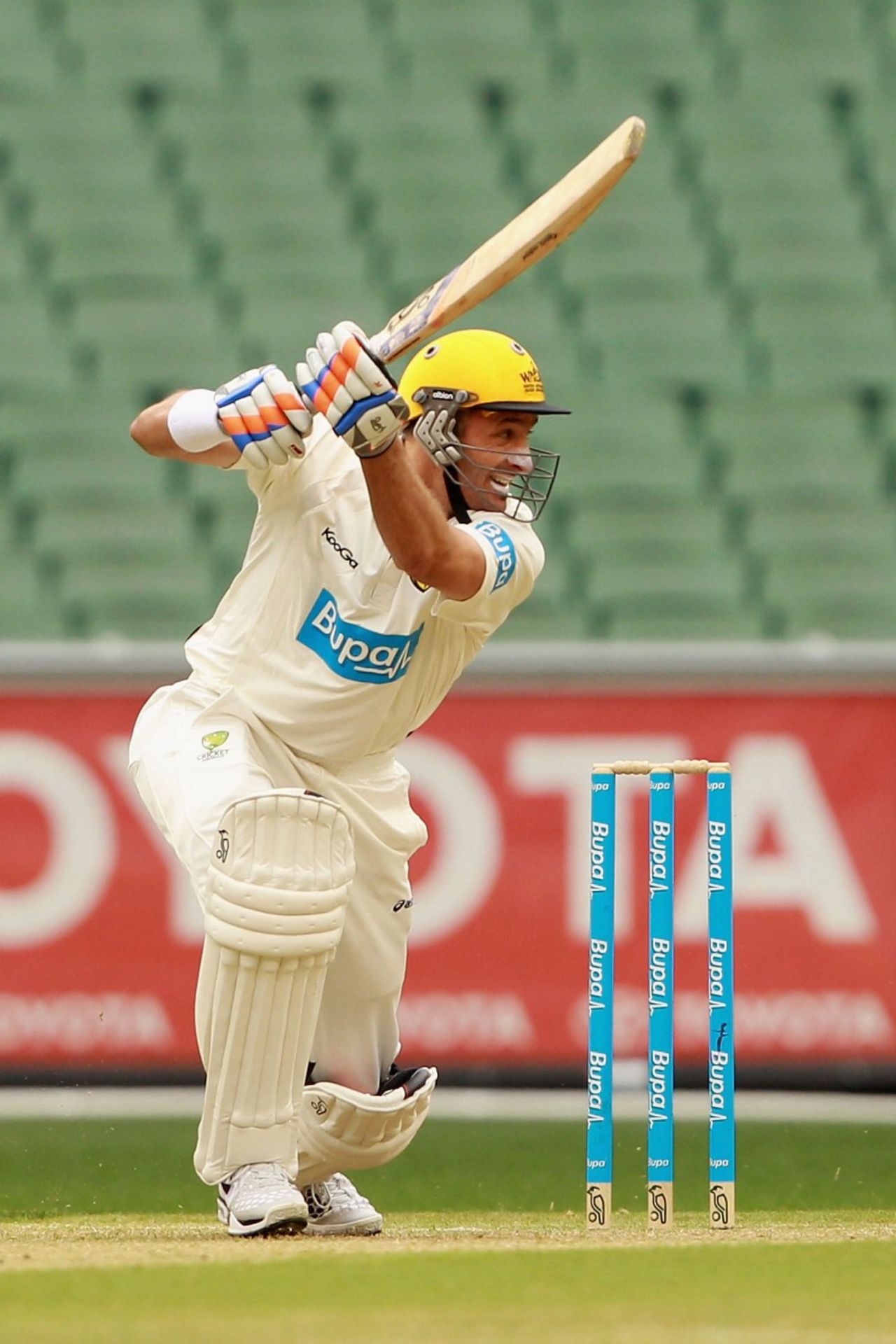 Michael Hussey drives one through point