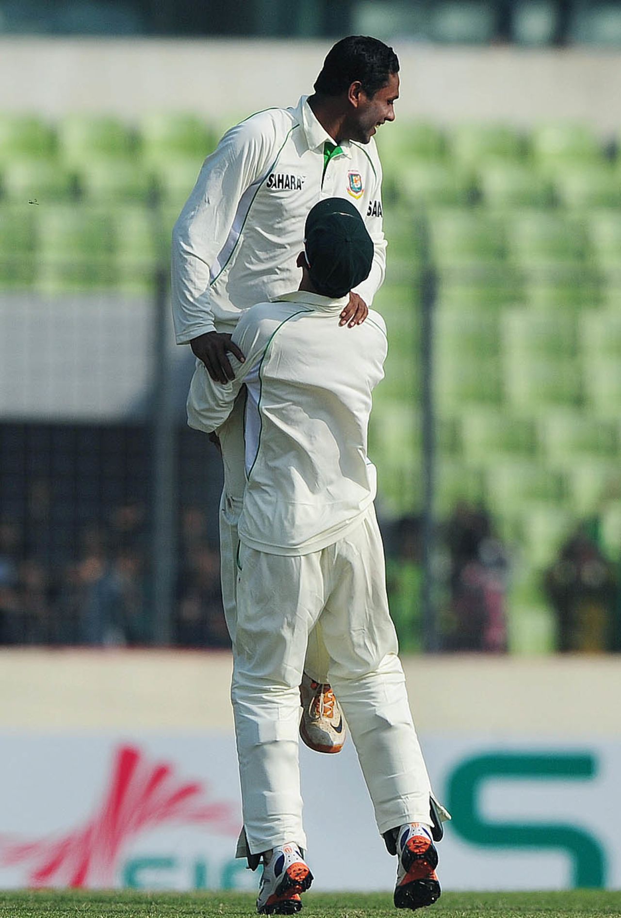 Sohag Gazi is lifted by one of his team-mates after Kieran Powell was dismissed, Bangladesh v West Indies, 1st Test, 1st day, Mirpur, November 13, 2012