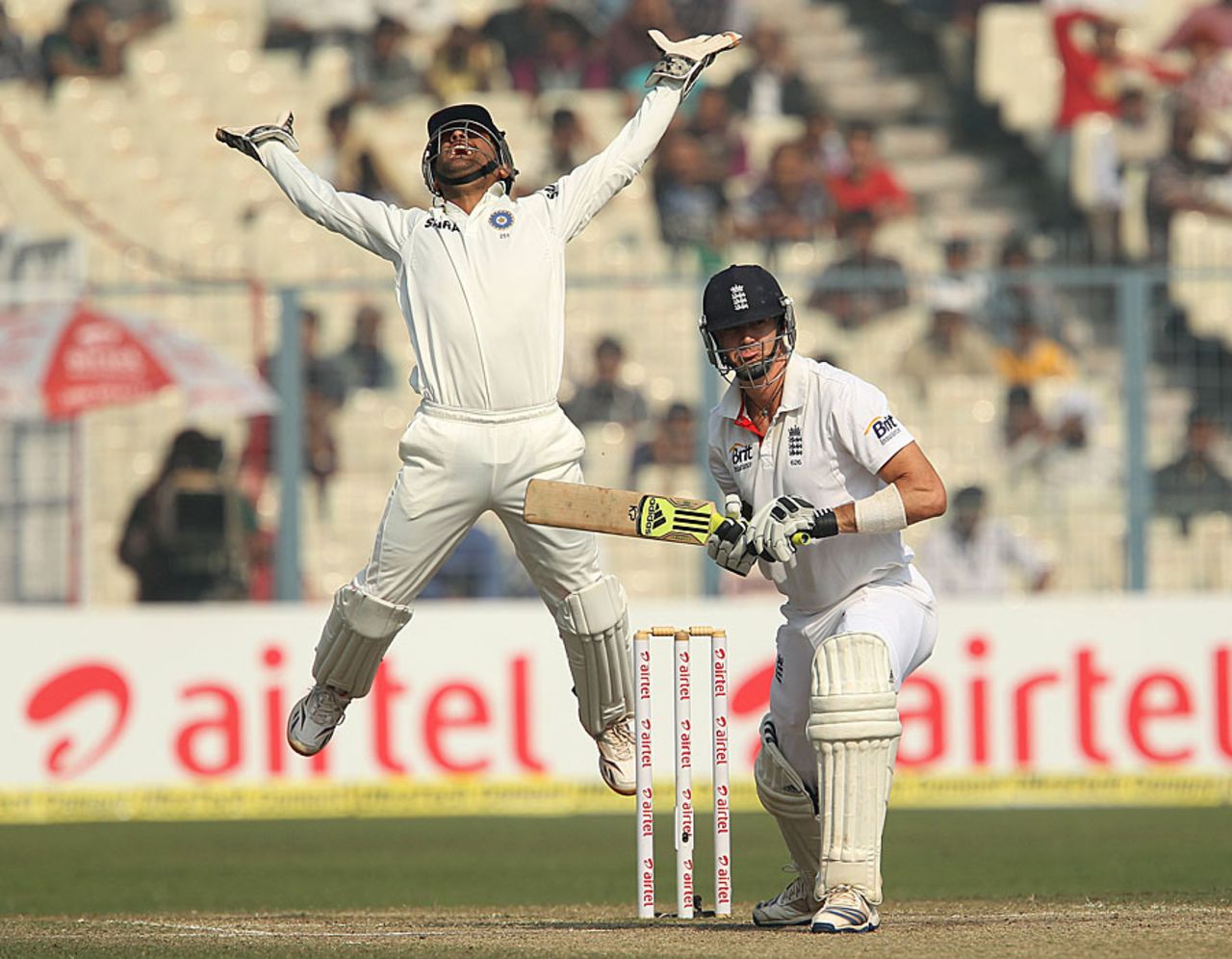 MS Dhoni leaps after taking a catch to get Kevin Pietersen out, India v England, 3rd Test, Kolkata, 5th day, December 8, 2012