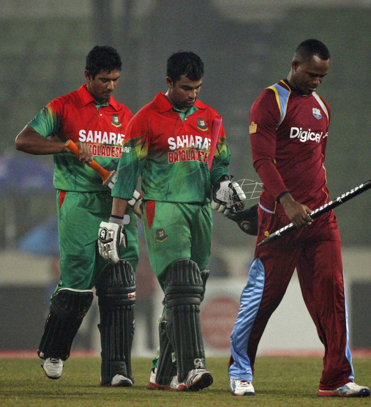 Marlon Samuels, Tamim Iqbal and Mahmudullah walk off the field, Bangladesh v West Indies, only Twenty20, Mirpur, December 10, 2011