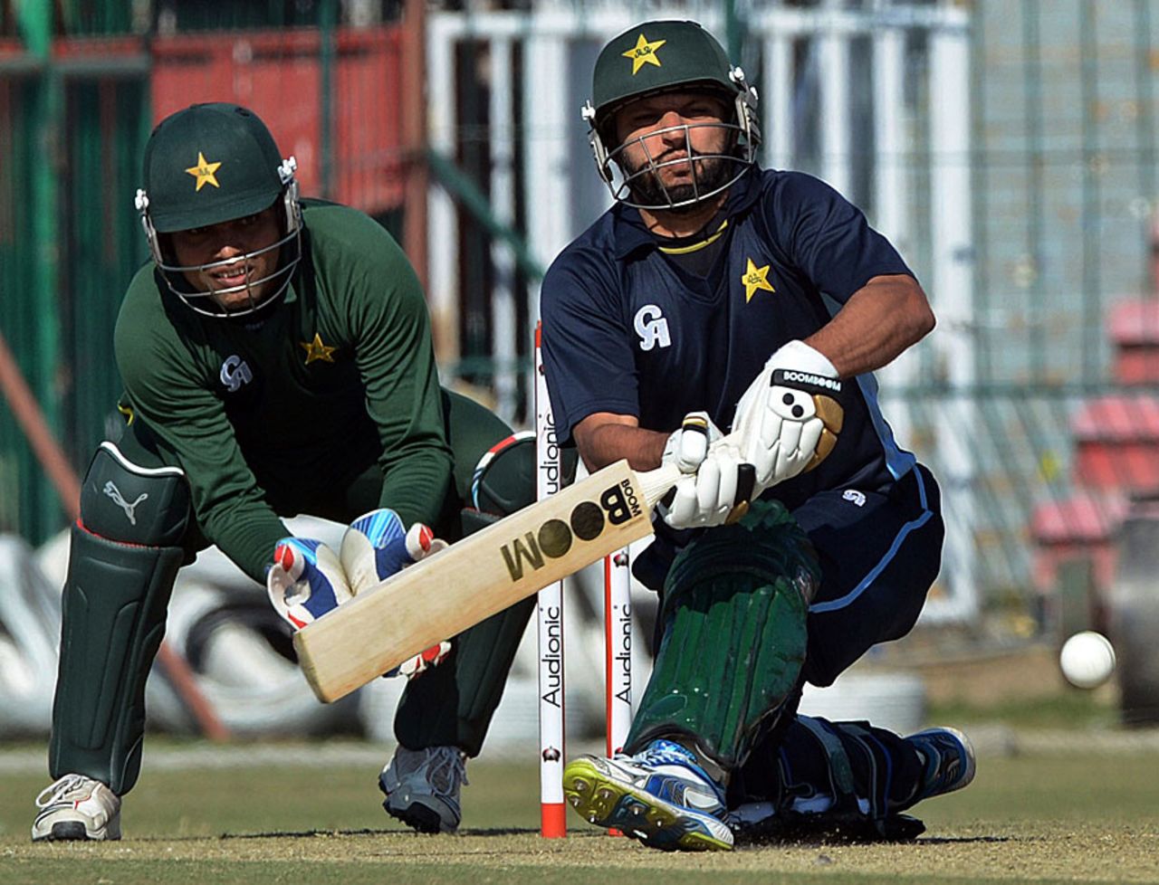 Shahid Afridi sweeps during a practice match, Lahore, December 19, 2012