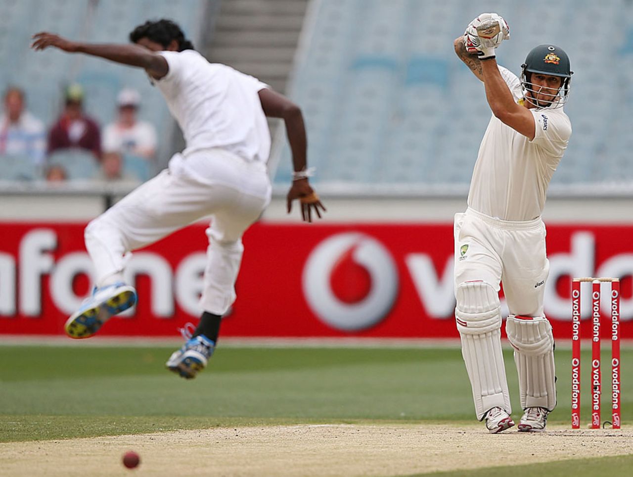 Shaminda Eranga gets out of the way of a powerful Mitchell Johnson straight drive, Australia v Sri Lanka, 2nd Test, Melbourne, 3rd day, December 28, 2012