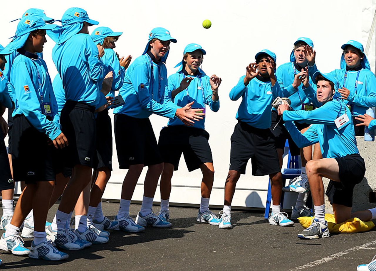 Ballboys at the Australian Open play cricket during a break, Melbourne, January 20, 2013