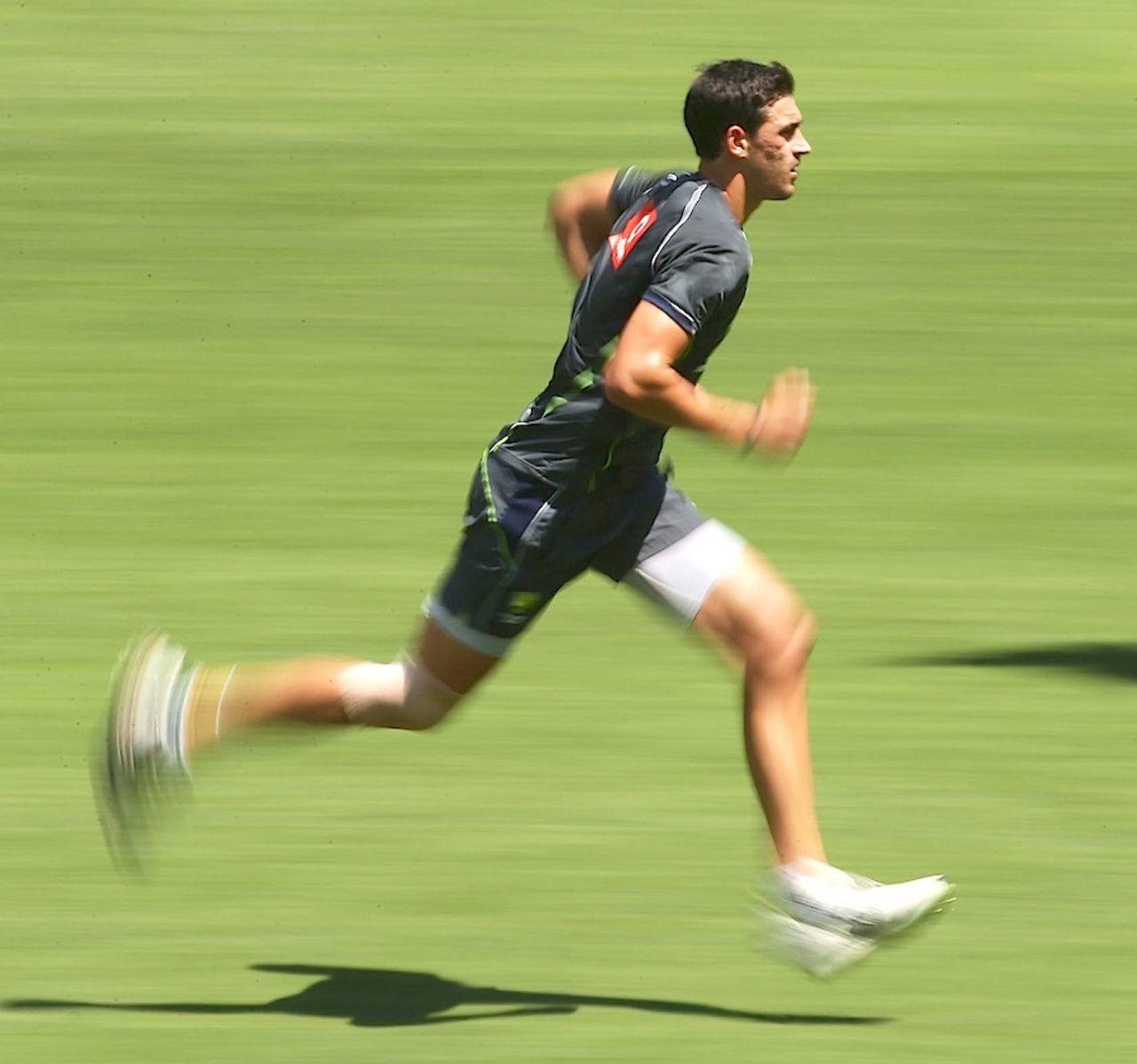 Mitchell Starc steams in during practice, Sydney, January 25, 2012