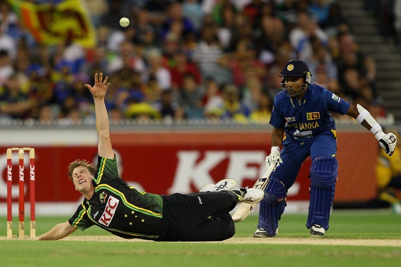 James Faulkner attempts to stop the ball off his own bowling, Australia v Sri Lanka, 2nd T20, Melbourne, January 28, 2013