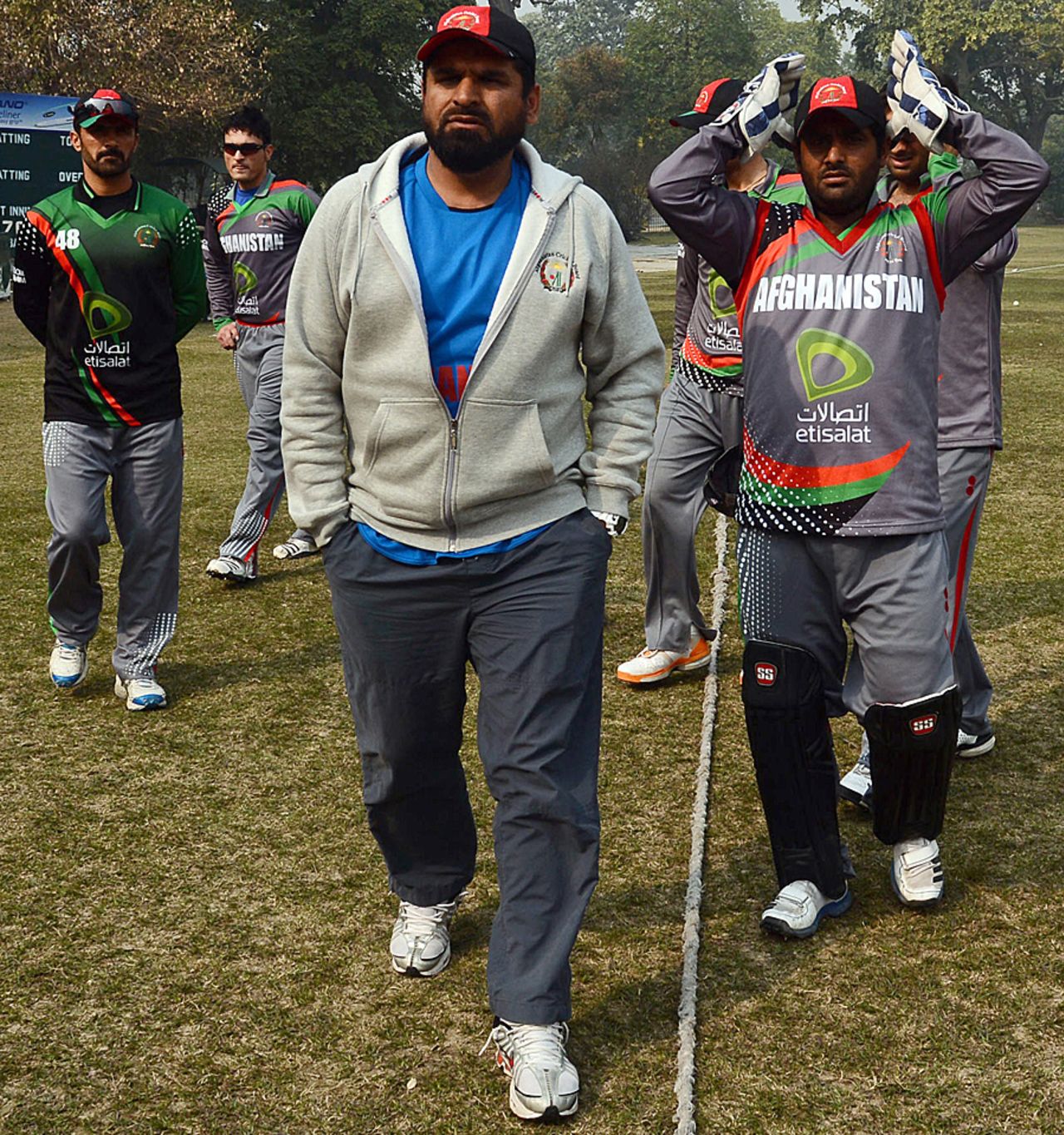 Afghanistan's coach Kabir Khan with players at a coaching camp, Lahore, January 31, 2013