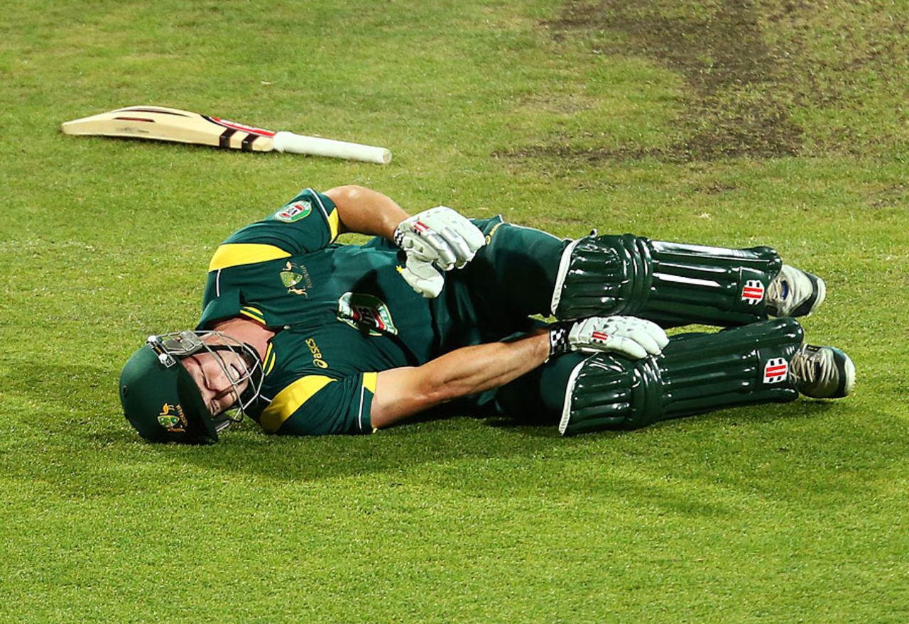 Shaun Marsh writhes in pain after hurting his knee completing the run for his hundred, Australia A v England Lions, Hobart, February 16, 2013
