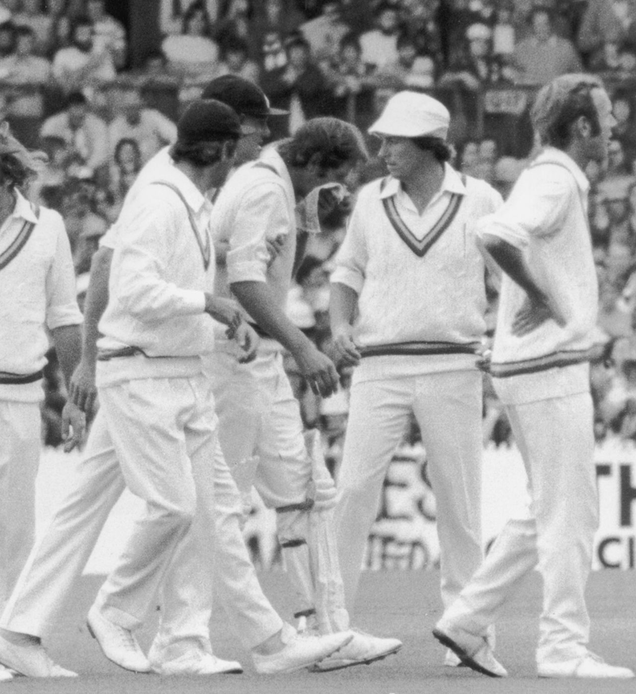 The England players gather around Rick McCosker who broke his jaw, Australia v England, Centenary Test, 1st day, Melbourne, March 1977