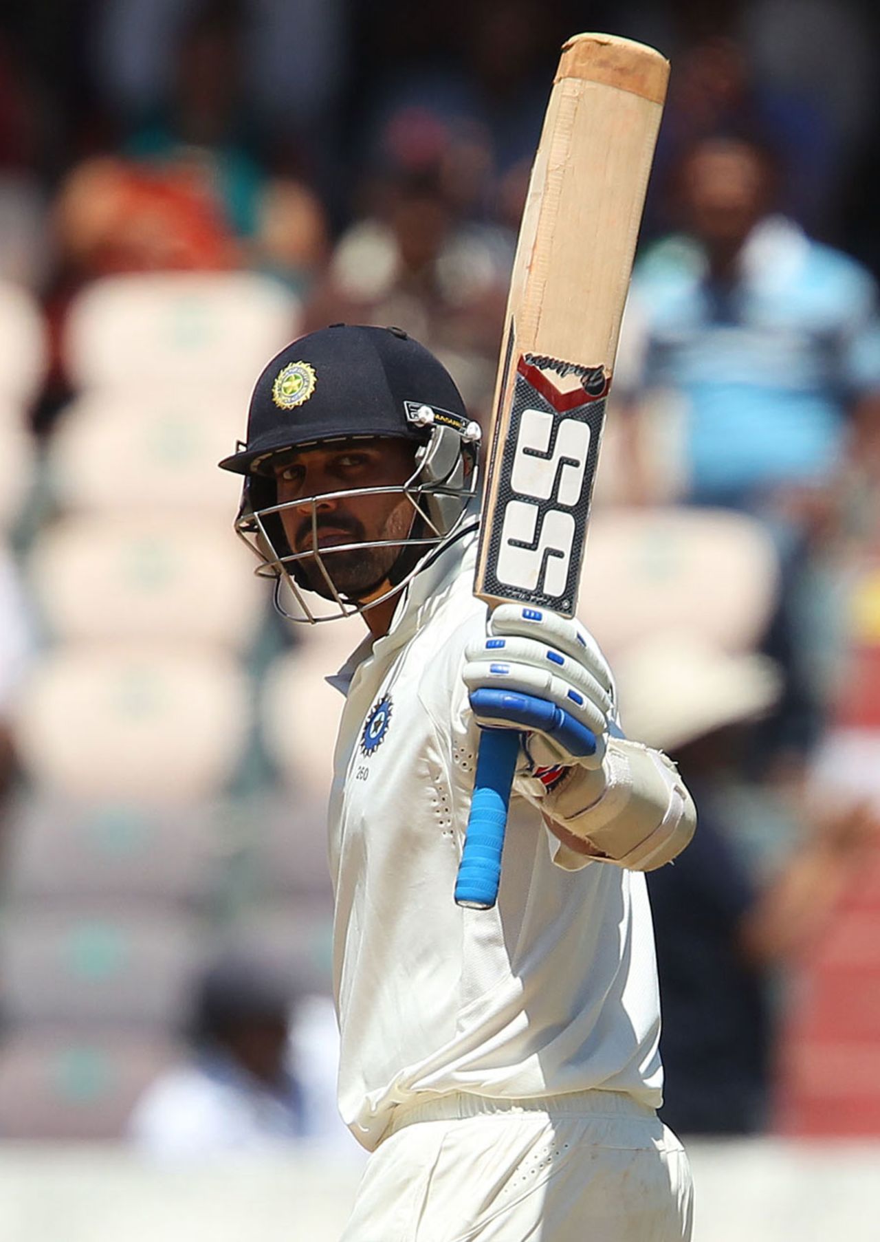 Cheteshwar Pujara raises his bat after reaching his half-century, India v Australia, 2nd Test, Hyderabad, 2nd day, March 3, 2013