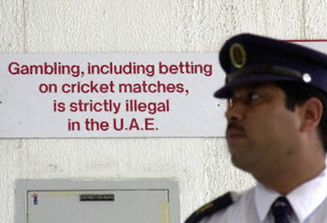 A security guard at Sharjah stadium stands in front of a sign prohibiting gambling and betting, Final at Sharjah, Pakistan v Sri Lanka, 20 April 2001
