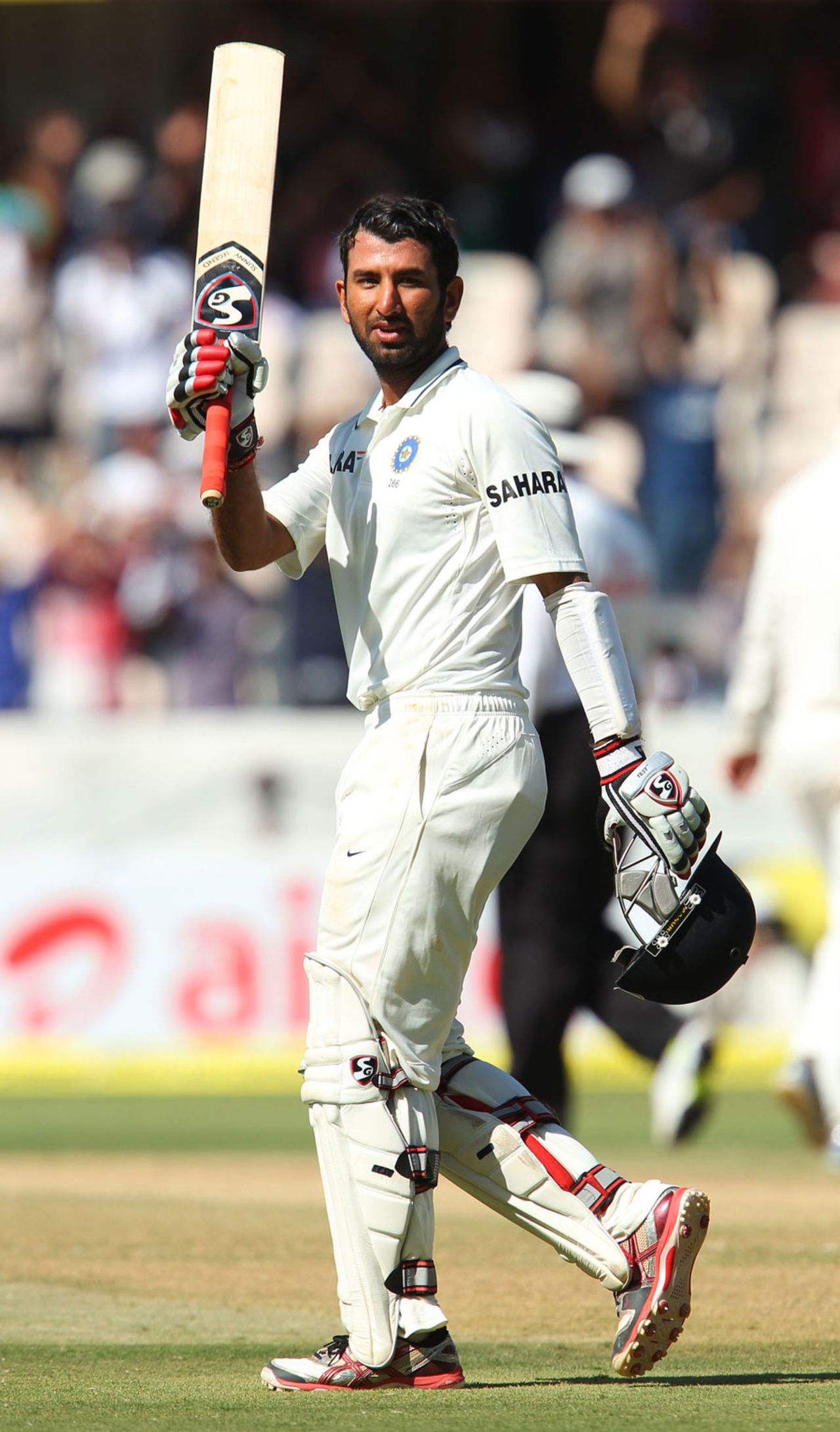 Cheteshwar Pujara raises his bat after scoring his fourth Test century, India v Australia, 2nd Test, Hyderabad, 2nd day, March 3, 2013