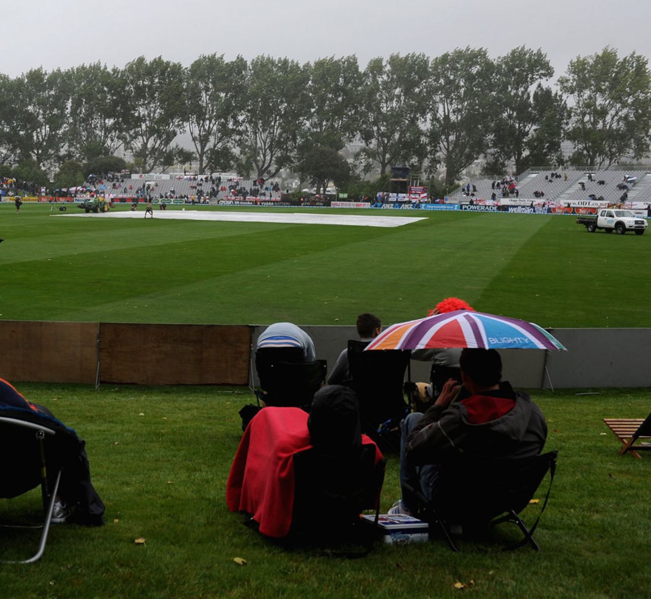 Spectators take cover as rain falls at University Oval, New Zealand v England, 1st Test, Dunedin, 1st day, March, 6, 2013