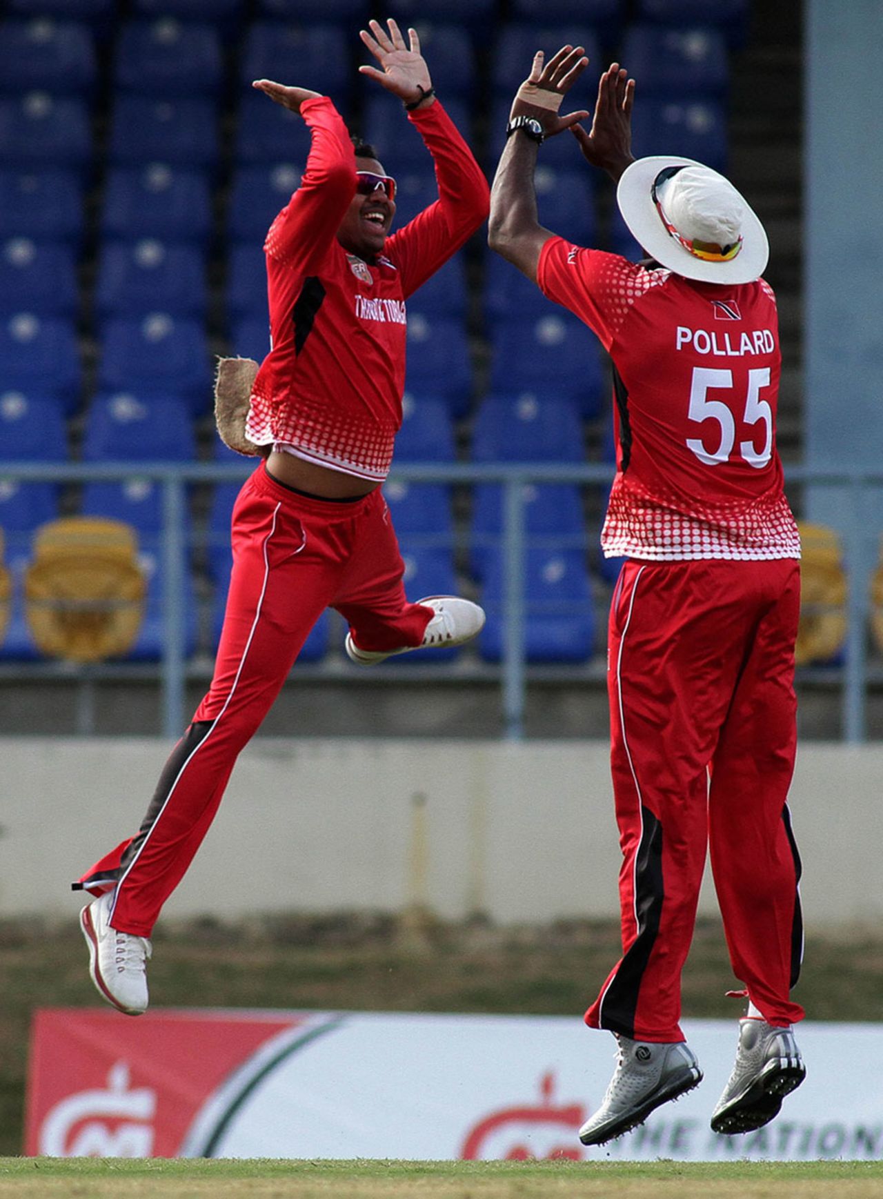 Sunil Narine and Kieron Pollard celebrate the fall of a wicket, Trinidad & Tobago, Regional Super50, March 11, 2013