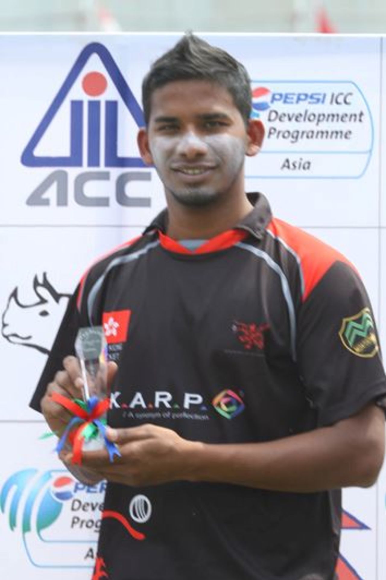 Nadeem Ahmed shows off his Man of the Match Award for taking 3-18 against Nepal at the ACC Twenty20 Cup 2013 in Kathmandu