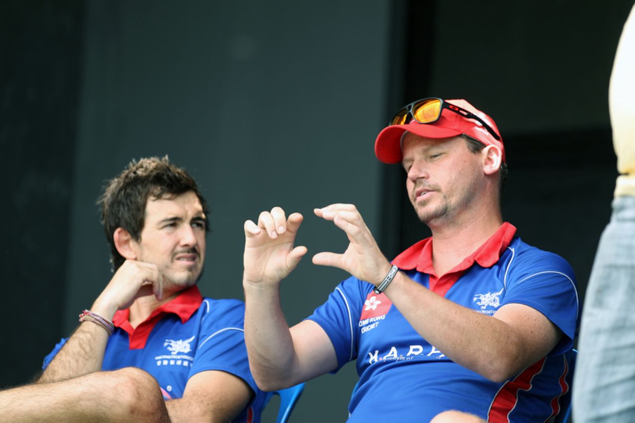 Hong Kong National Coach Charlie Burke waxes lyrical, with Christopher Pedra (Hong Kong team physiotherapist)