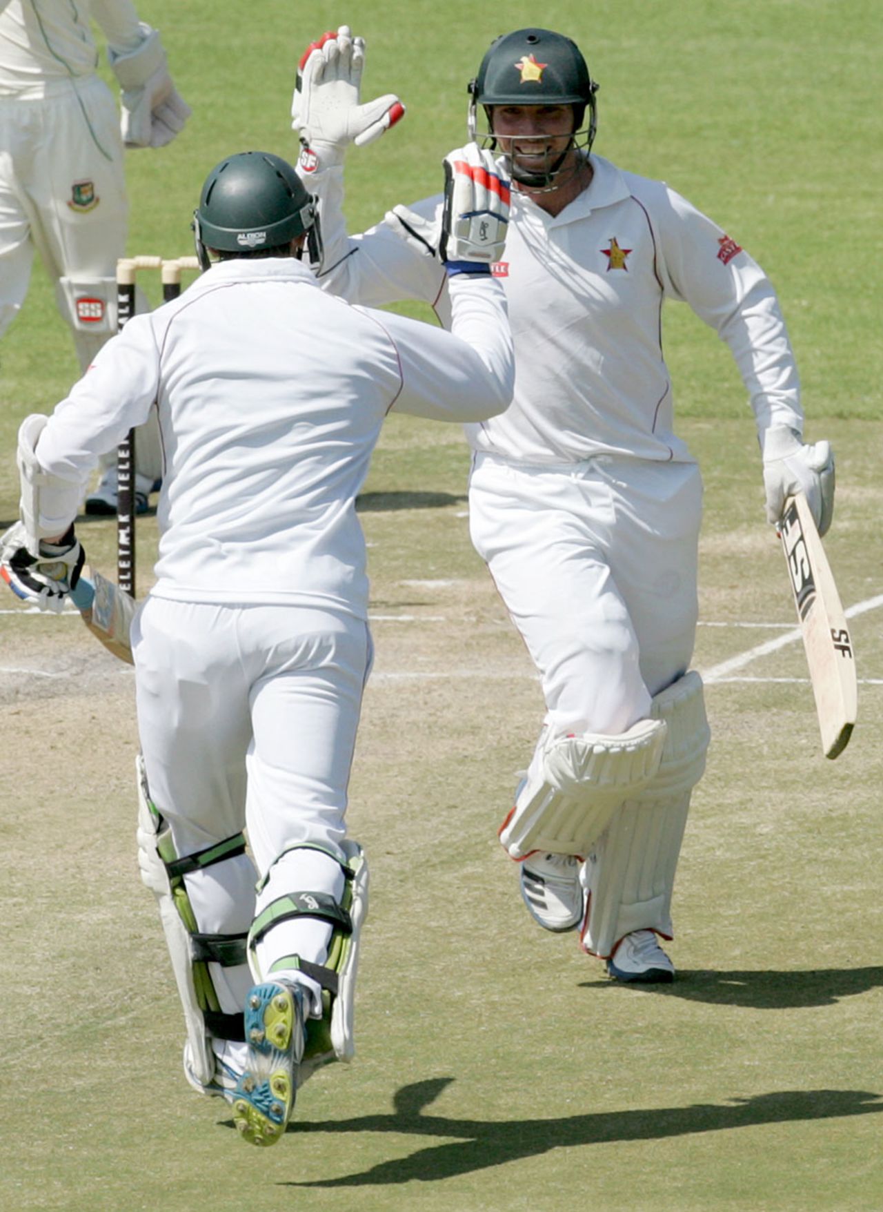 Brendan Taylor high-fives Keegan Meth as he completes another hundred, Zimbabwe v Bangladesh, 1st Test, 4th day, Harare, April 20, 2013