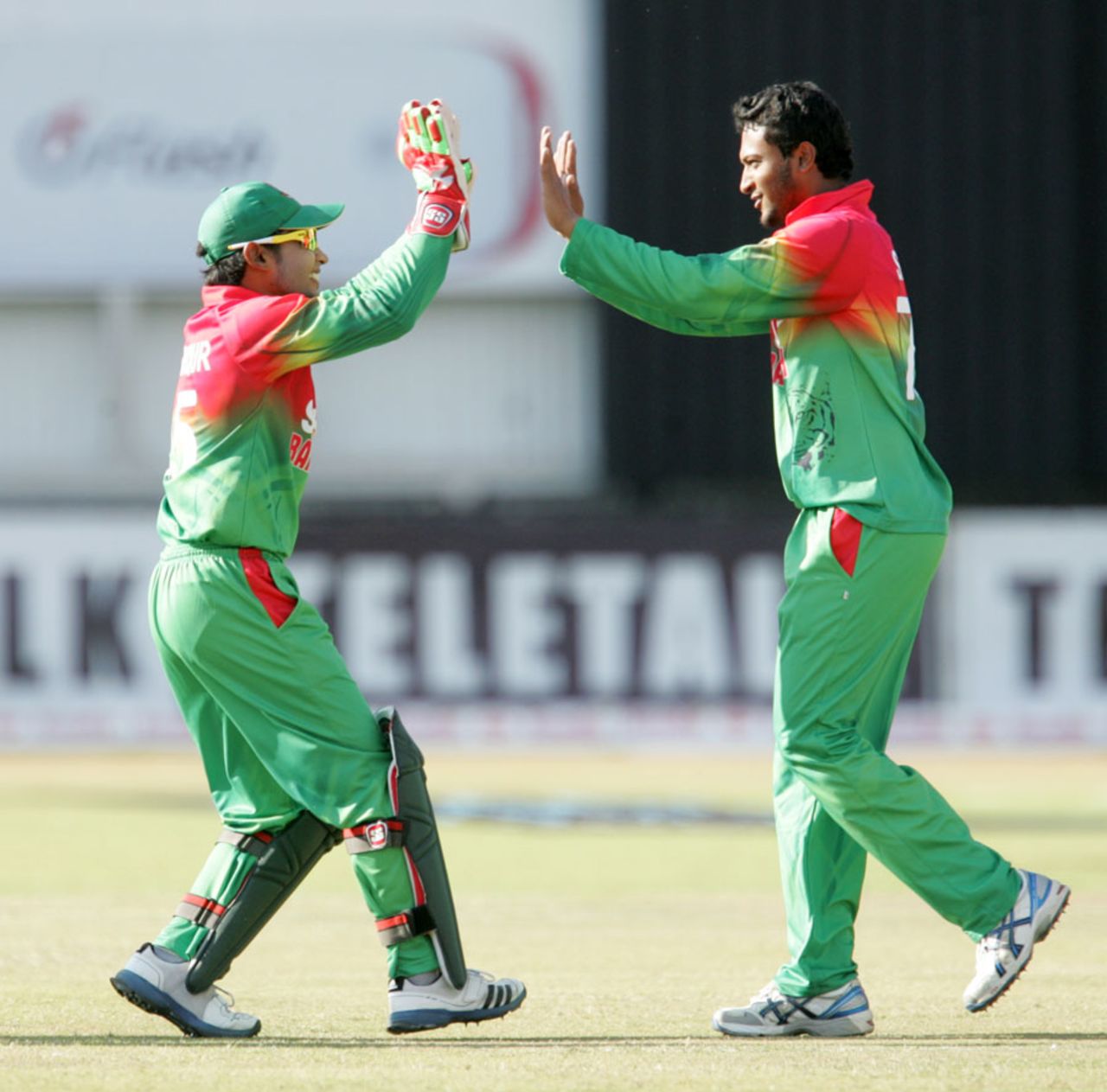 Mushfiqur Rahim and Shakib Al Hasan celebrate the fall of a wicket, Zimbabwe v Bangladesh, 2nd T20I, Bulawayo, May 12, 2013