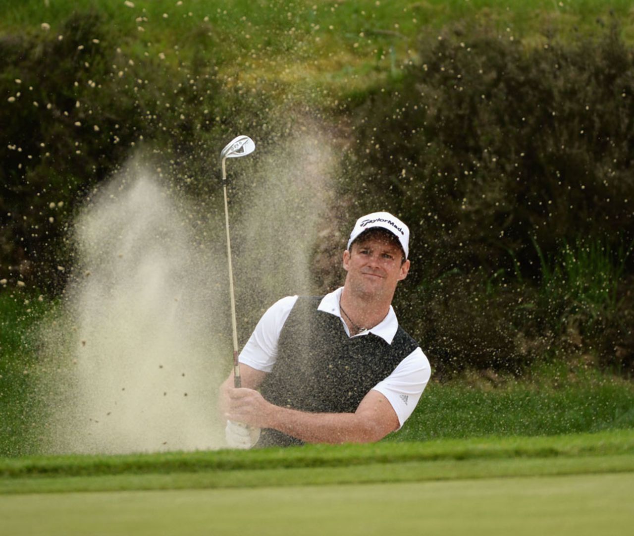 Former England captain Andrew Strauss plays out of a bunker at Wentworth, BMW Championships, Wentworth, May, 22, 2013