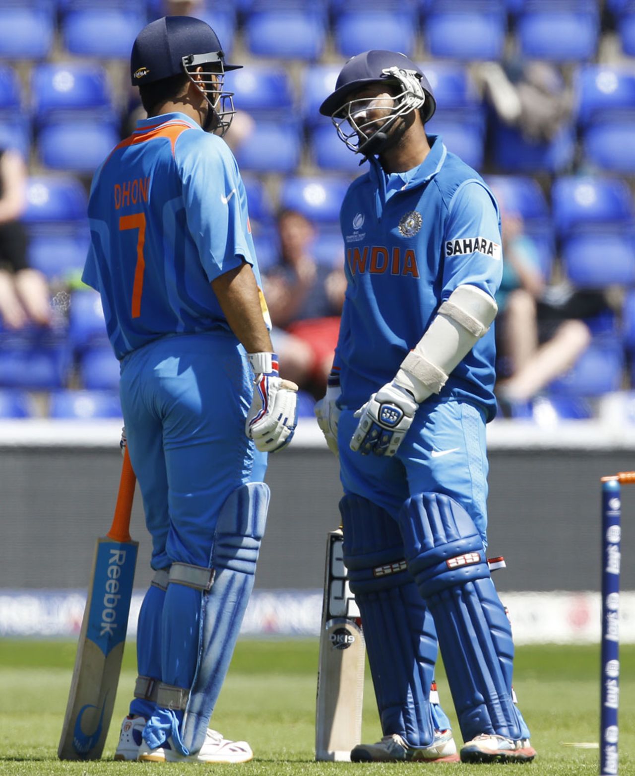 Dinesh Karthik and MS Dhoni take a break between overs, Australia v India, Champions Trophy warm-up, Cardiff, June 4, 2013
