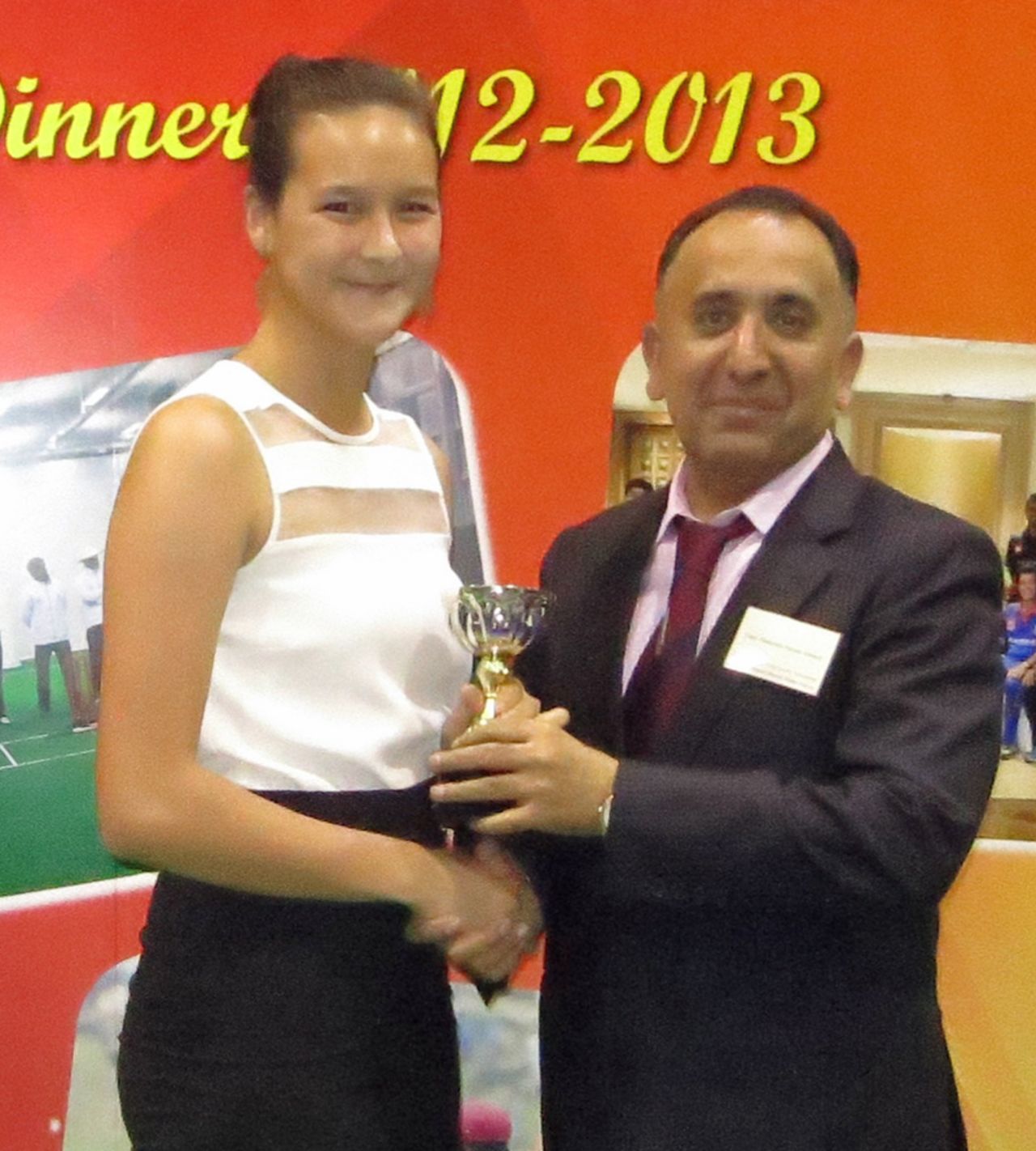 Mariko Hill collects her Hong Kong Woman Cricketer of the Year trophy from outgoing HKCA President Capt. Saleem Ahmed Shahzada at the HKCA 2012-13 Awards Dinner at Kowloon Cricket Club on 5th June 2013