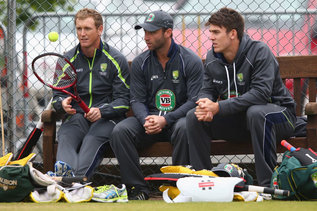 George Bailey fancies a little tennis as Mitchell Marsh and Phil Hughes watch at a practice session before their match against New Zealand, Edgbaston, June 11, 2013