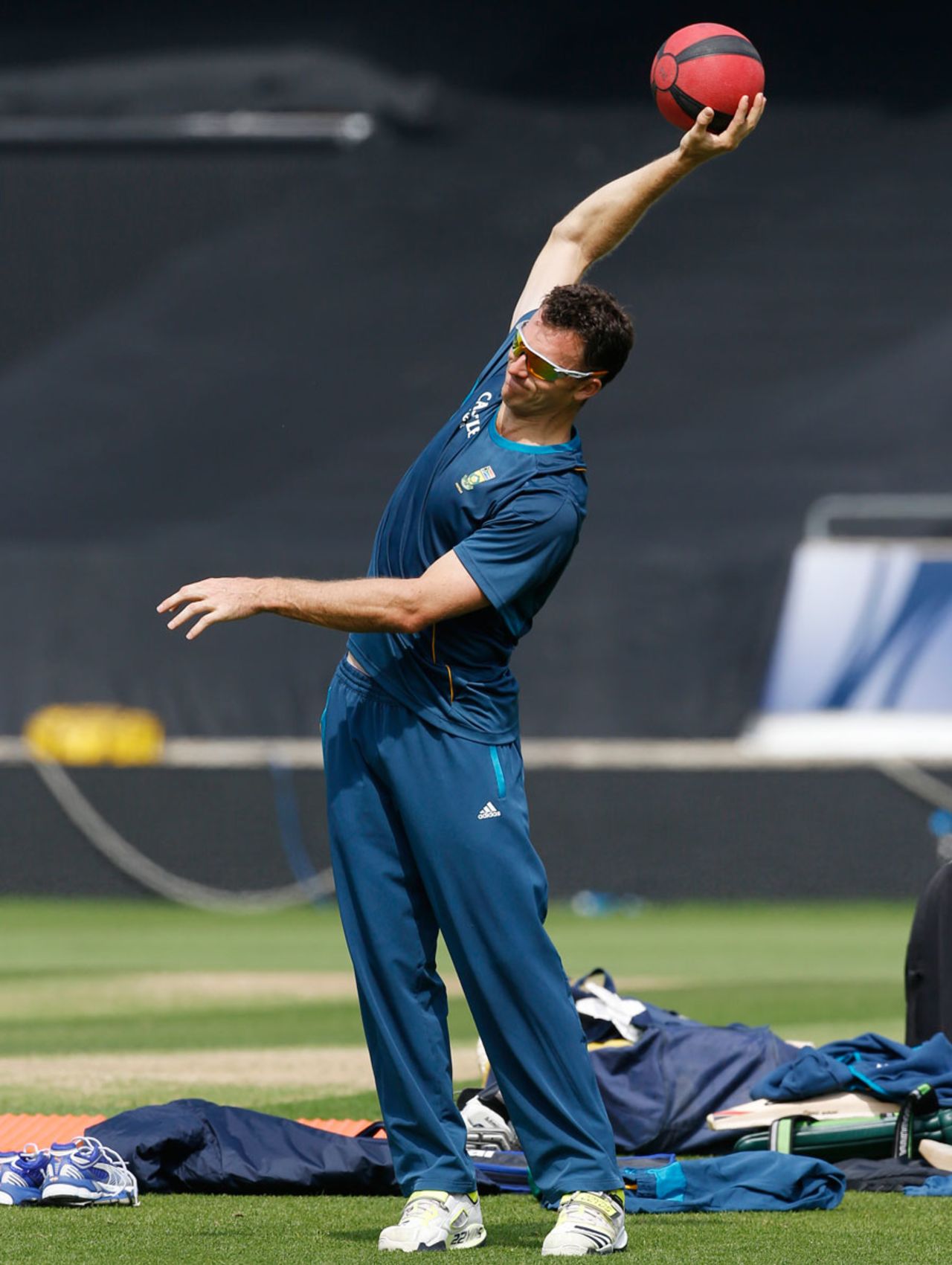 Ryan McLaren does some stretching exercises with a medicine ball, London, June 18, 2013