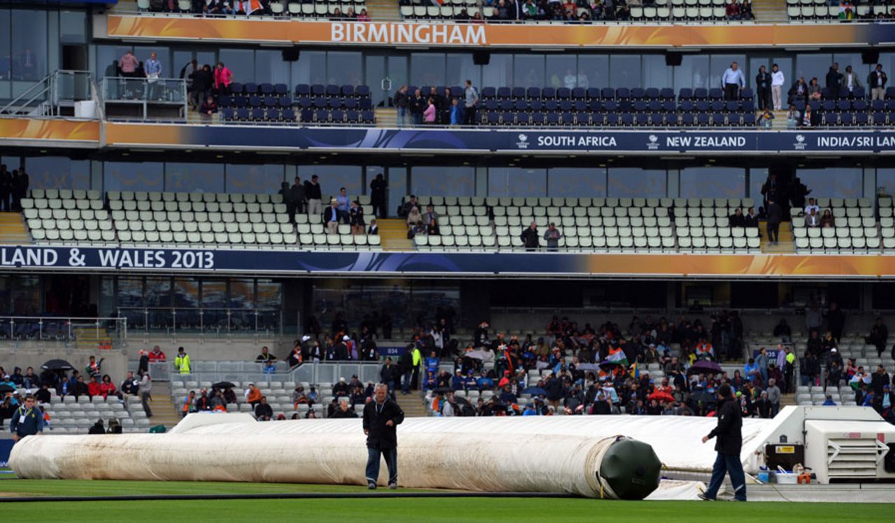 Ground staff roll out covers on to the pitch at Edgbaston, England v India, Champions Trophy final, Edgbaston, June 23, 2013