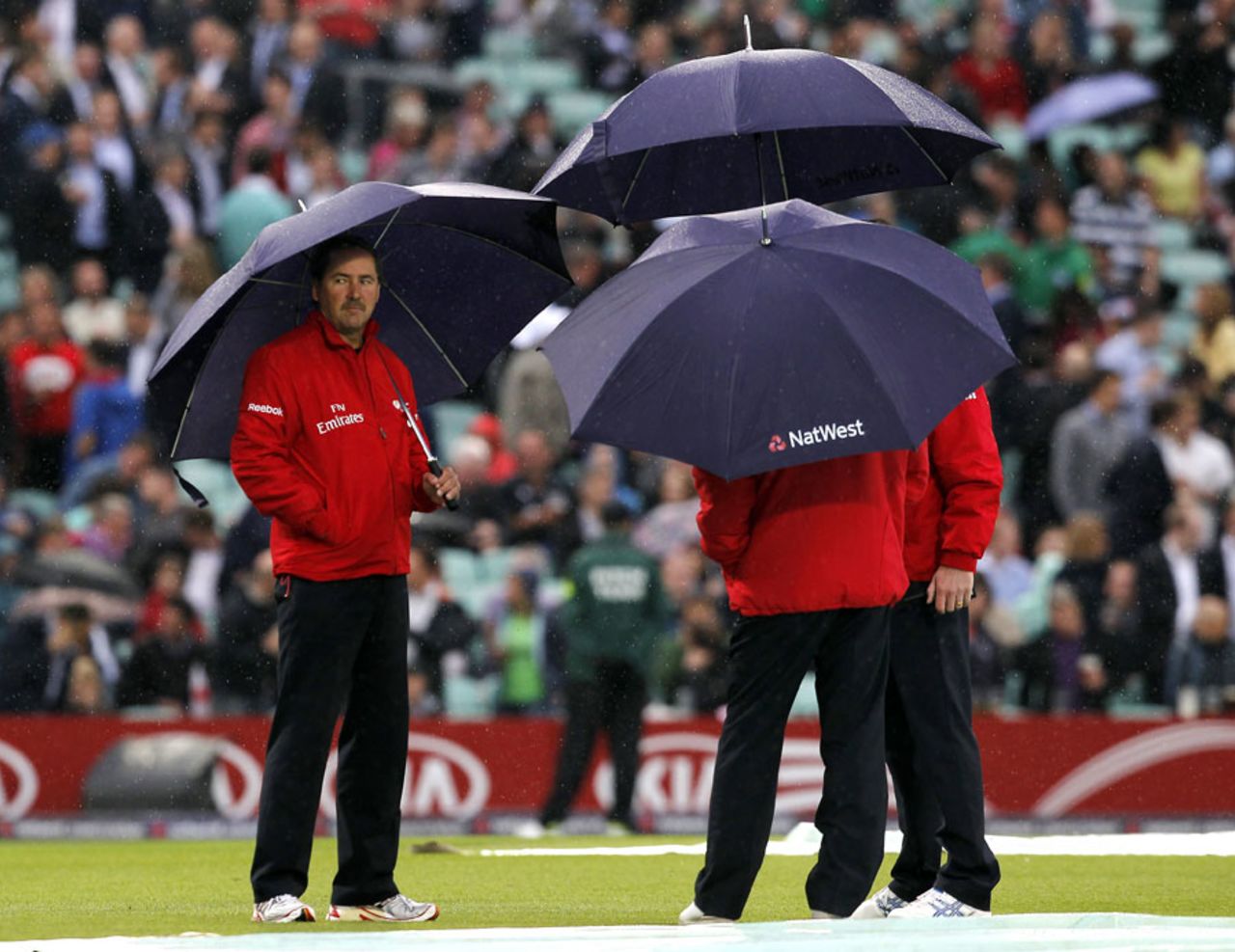 The umpires take cover from the rain, England v New Zealand, 2nd T20, The Oval, June 27, 2013
