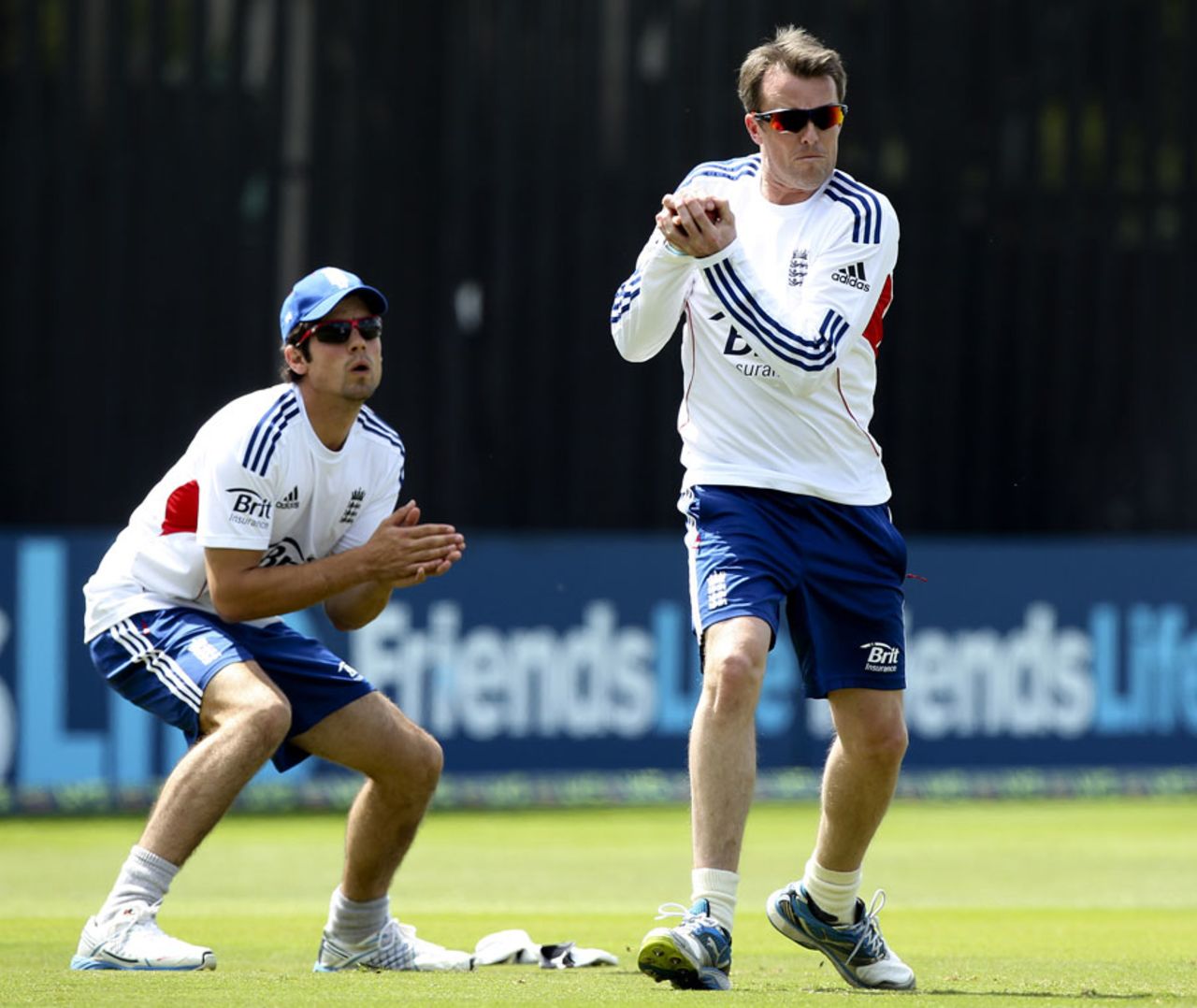 Graeme Swann takes a catch in practise as Alastair Cook looks on, Chelmsford, June, 29, 2013