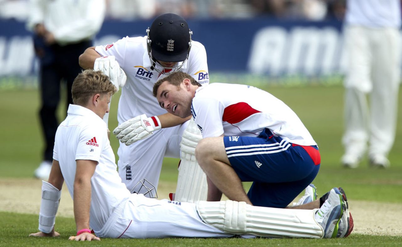 Joe Root receives some treatment after being hit on the knee, Essex v England, 1st day, Chelmsford, June 30, 2013