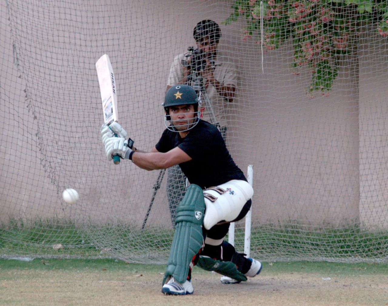 Umar Akmal has a bat in the nets, Lahore, July 2, 2013