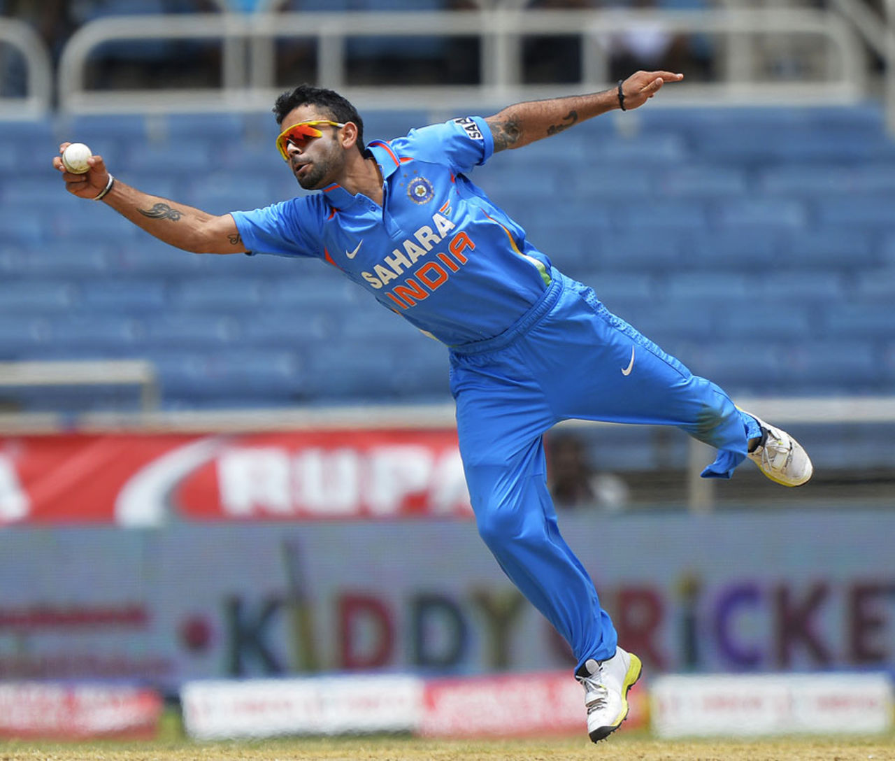 Kohli stretches to stop the ball off his own bowling, India v Sri Lanka, West Indies tri-series, Kingston, July 2, 2013