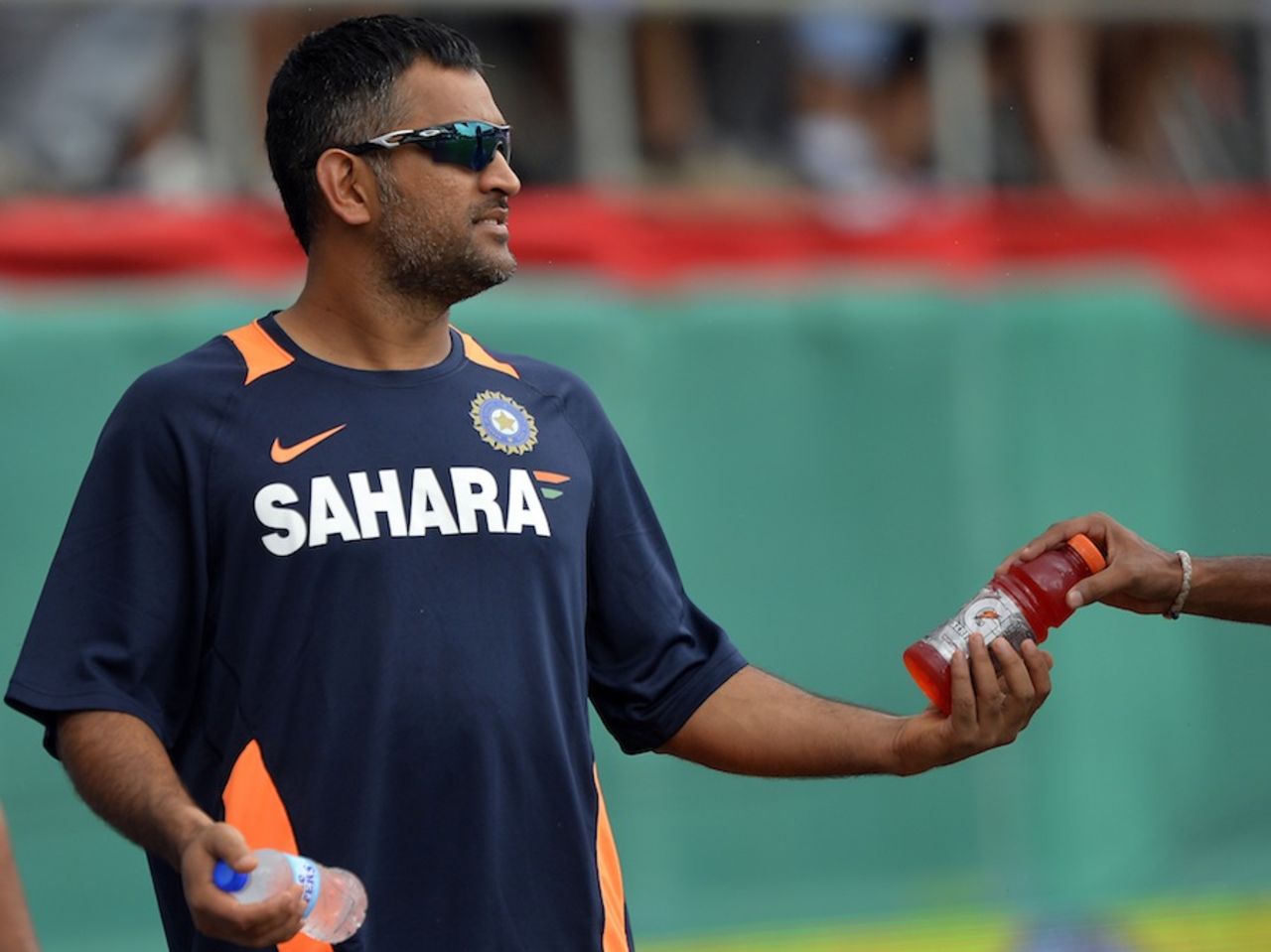 MS Dhoni gives drinks to his team-mates, West Indies v India, West Indies tri-series, Port of Spain, July 5, 2013