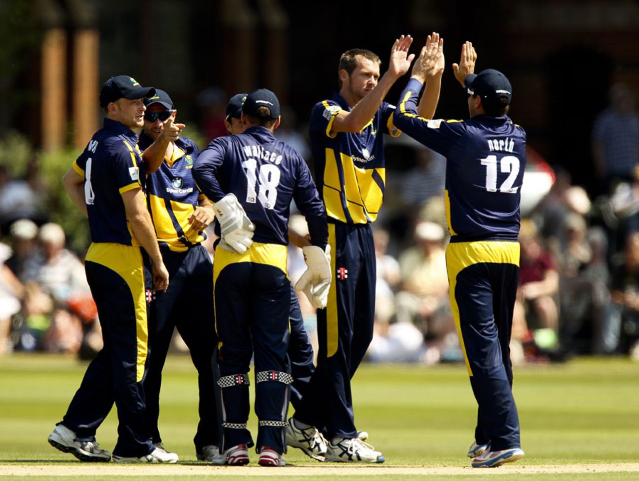 Michael Hogan gets a high five for one of his three wickets, Warwickshire v Glamorgan, FLt20 Midlands/Wales/West Group, Rugby, July 6, 2013