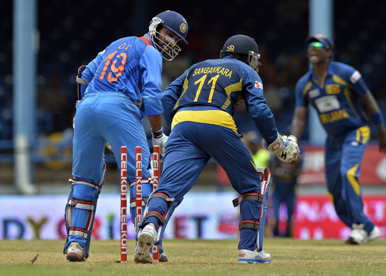 Dinesh Karthik looks back to find his stumps disturbed, India v Sri Lanka, West Indies tri-series, Port-of-Spain, July 9, 2013