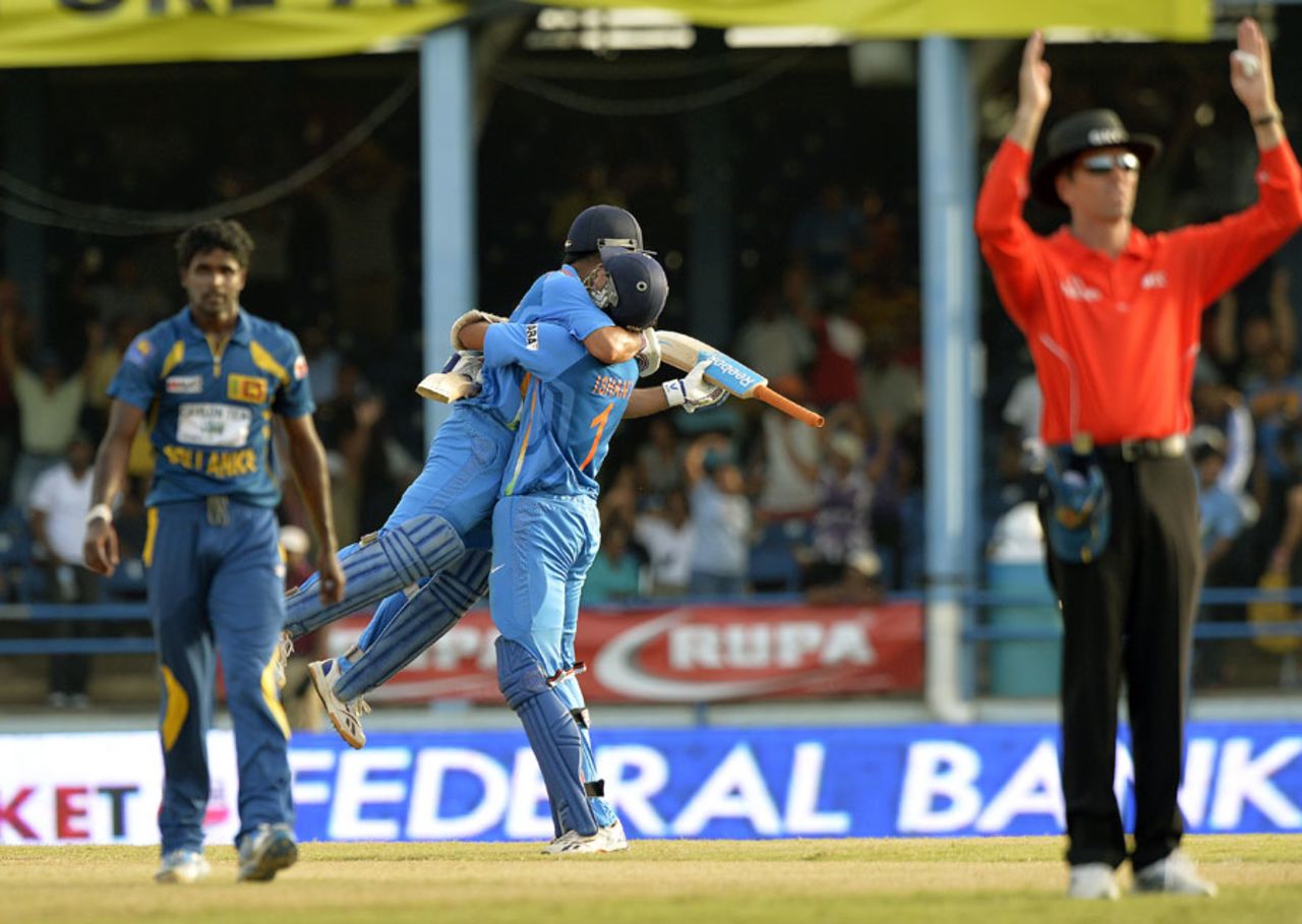Shaminda Eranga is forlorn while MS Dhoni and Ishant Sharma celebrate victory, India v Sri Lanka, tri-series final, Port-of-Spain, July 11, 2013