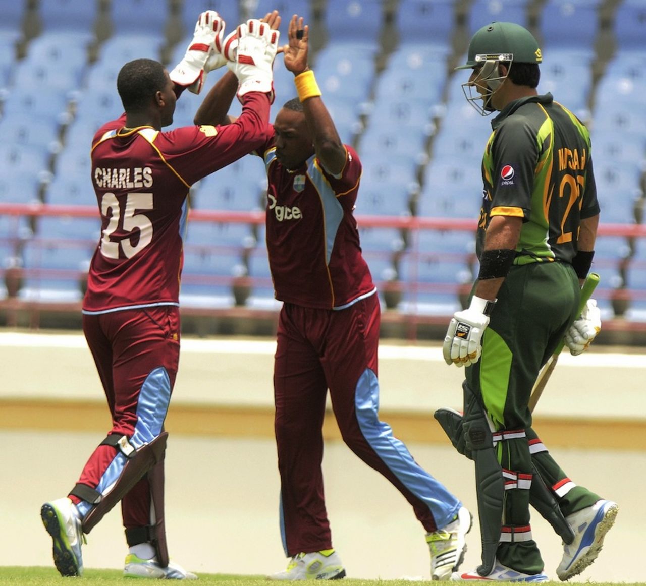 Dwayne Bravo shares high-fives after dismissing Misbah-ul-Haq, West Indies v Pakistan, 3rd ODI, St Lucia, July 19, 2013