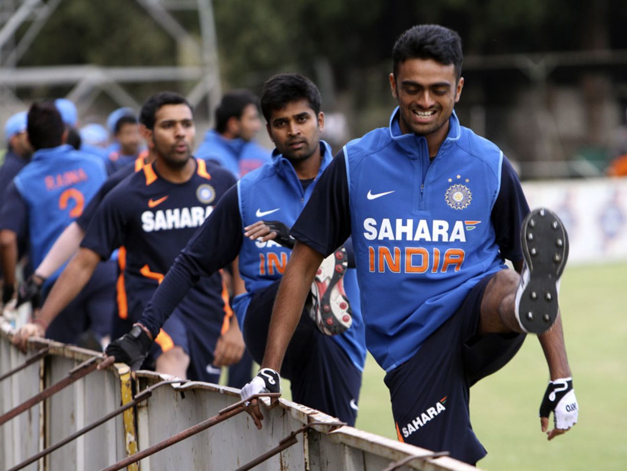 Jaydev Unadkat, Vinay Kumar and Rohit Sharma stretch during a practice session, Harare, July 22, 2013
