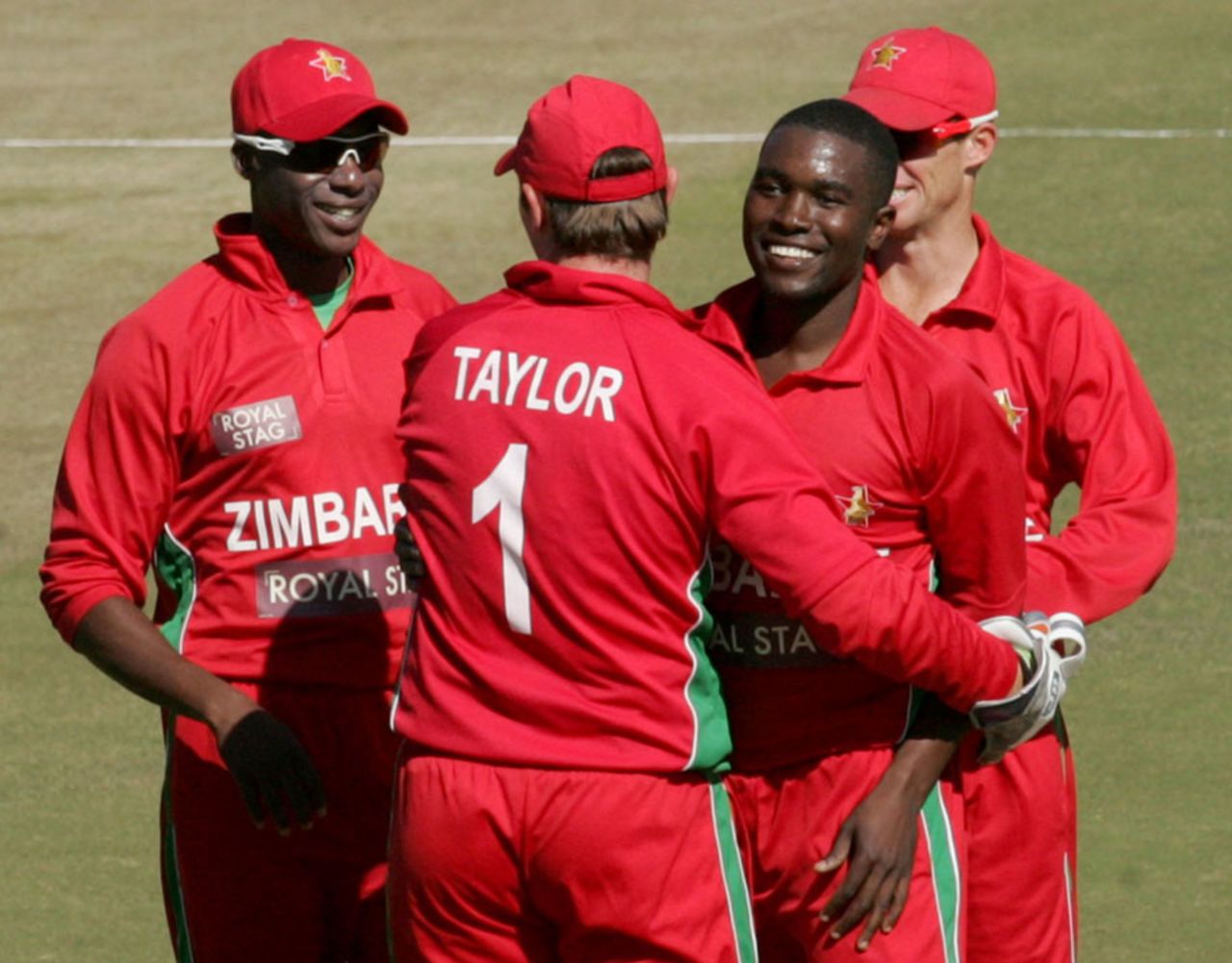 Elton Chigumbura celebrates a wicket with his team-mates, Zimbabwe v India, 1st ODI, Harare, July 24, 2013