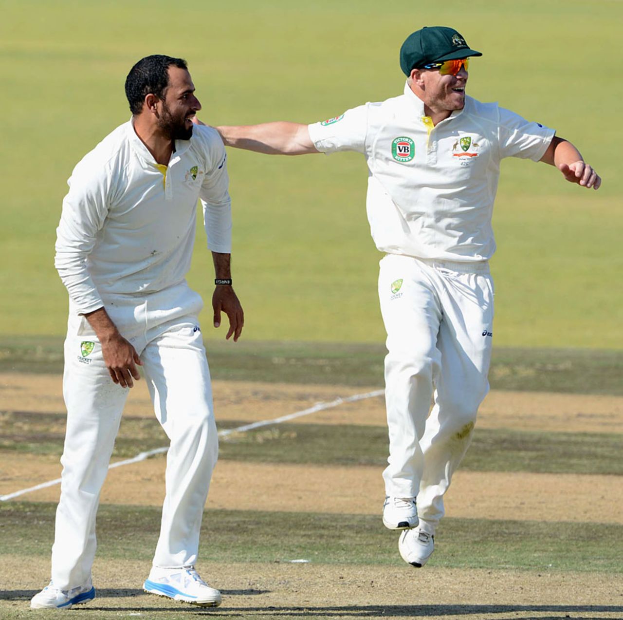 David Warner runs to congratulate Fawad Ahmed after a wicket, South Africa A v Australia A, 1st unofficial Test, 2nd day, Pretoria, July 25, 2013