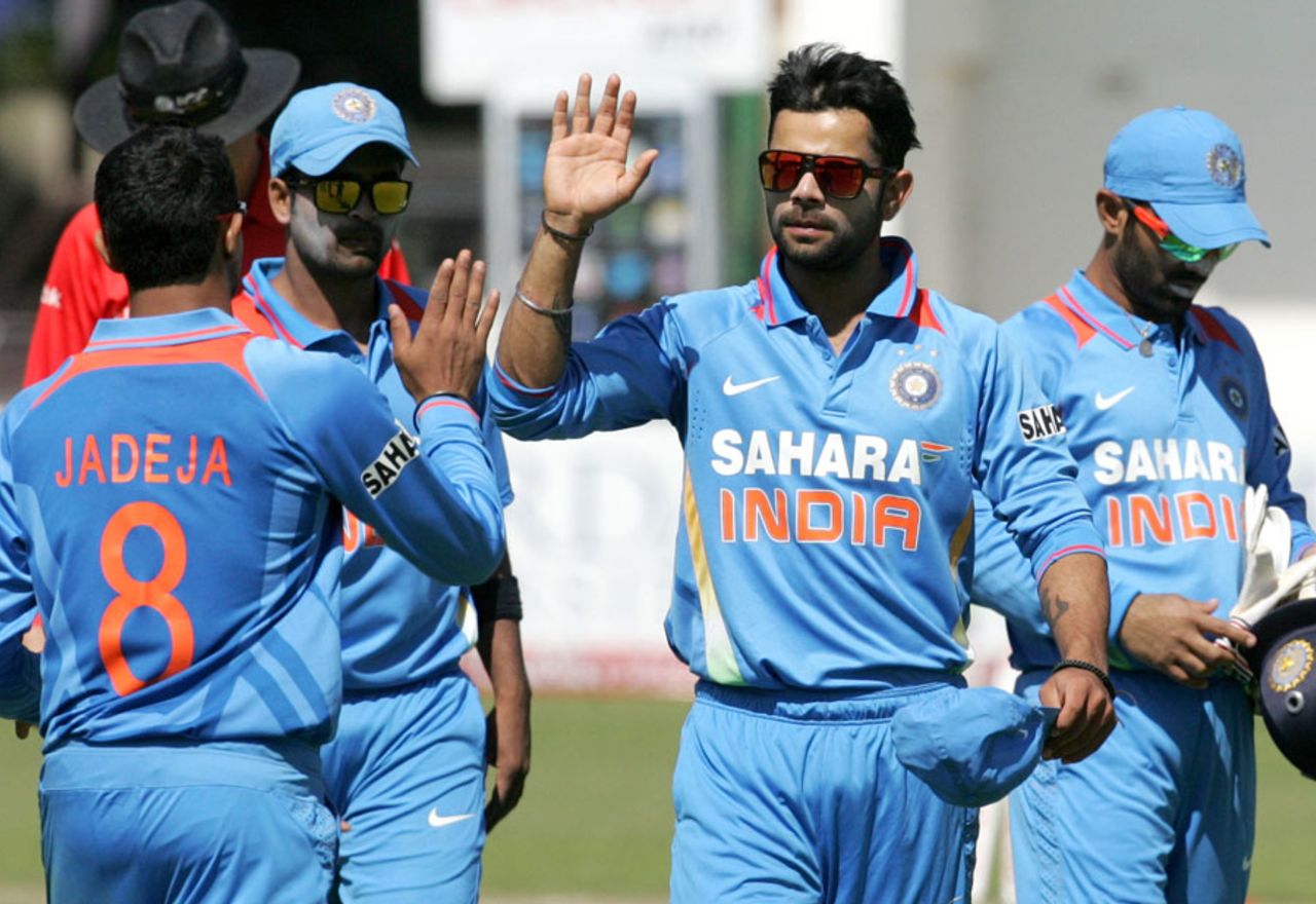 Virat Kohli and team-mates walk off after restricting Zimbabwe to 183, Zimbabwe v India, 3rd ODI, Harare, July 28, 2013 