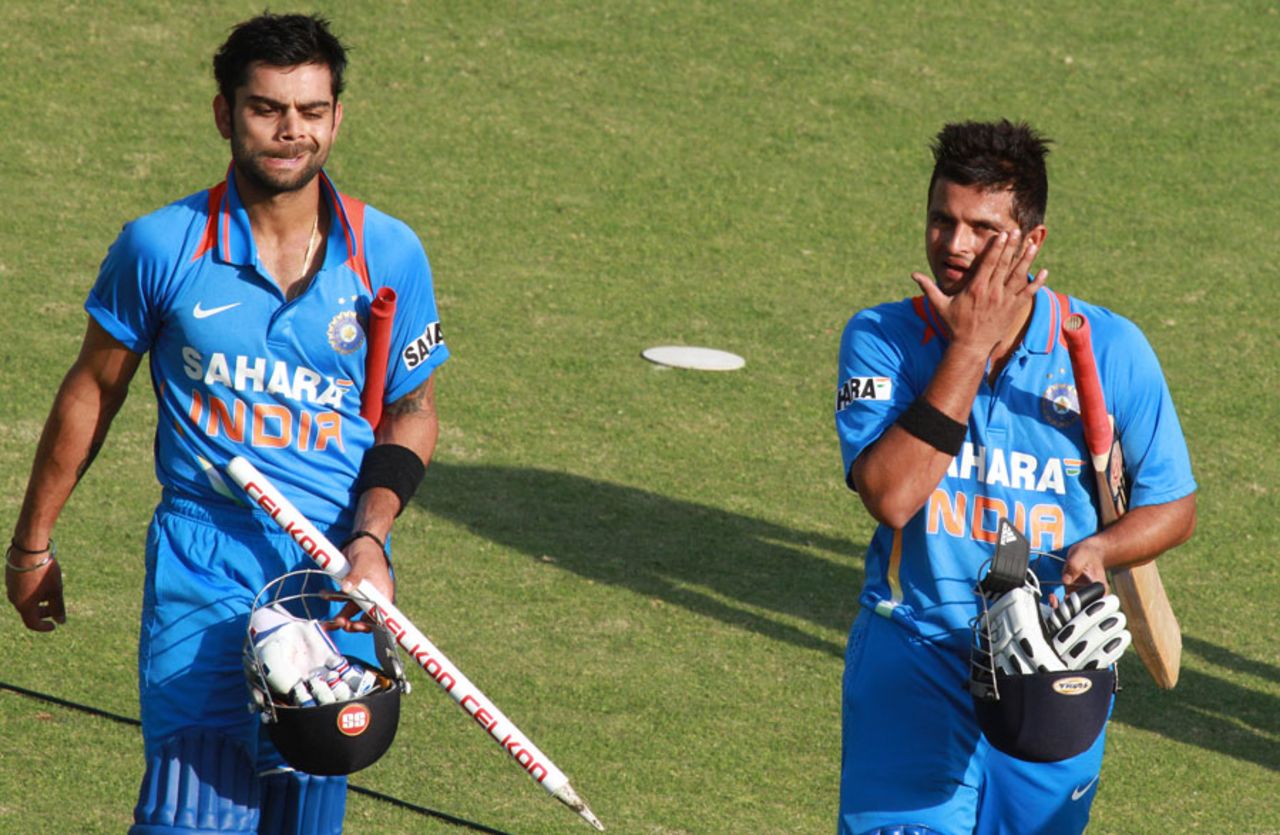 Virat Kohli and Suresh Raina walk off the field after India's win, Zimbabwe v India, 3rd ODI, Harare, July 28, 2013