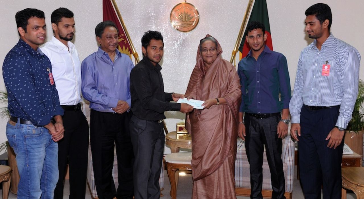 Bangladesh captain Mushfiqur Rahim hands over a Tk 20 lakh ($25,000) cheque to the country's Prime Minister Sheikh Hasina for the victims of Rana Plaza collapse, the country's worst industrial accident