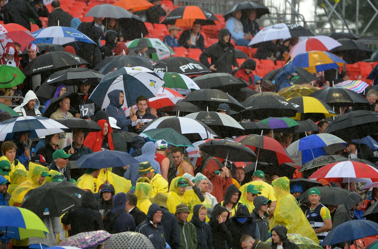 The brollies come out after the heavens open up, England v Australia, 3rd Investec Test, Old Trafford, 5th day, August 5, 2013