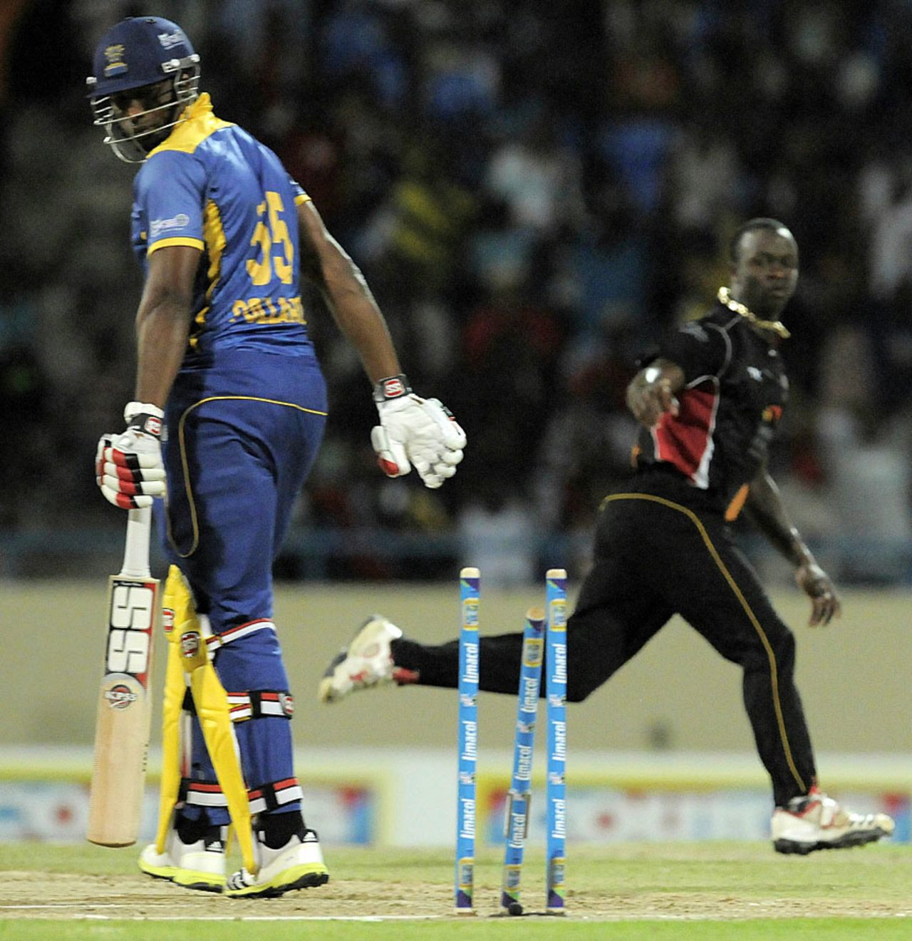 Kieron Pollard has his middle stump pushed back by Kemar Roach, Antigua Hawksbills v Barbados Tridents, CPL, North Sound, August 13, 2013