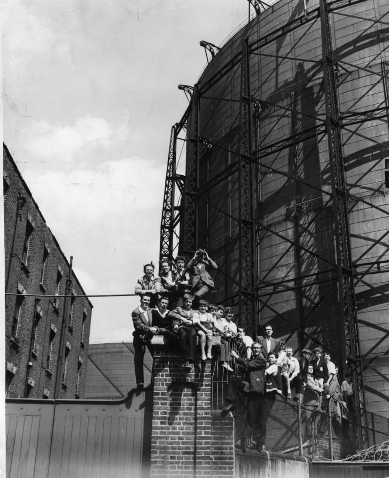 Spectators perch precariously on a wall outside The Oval with the Ashes at stake, England v Australia, The Oval, August 14, 1953
